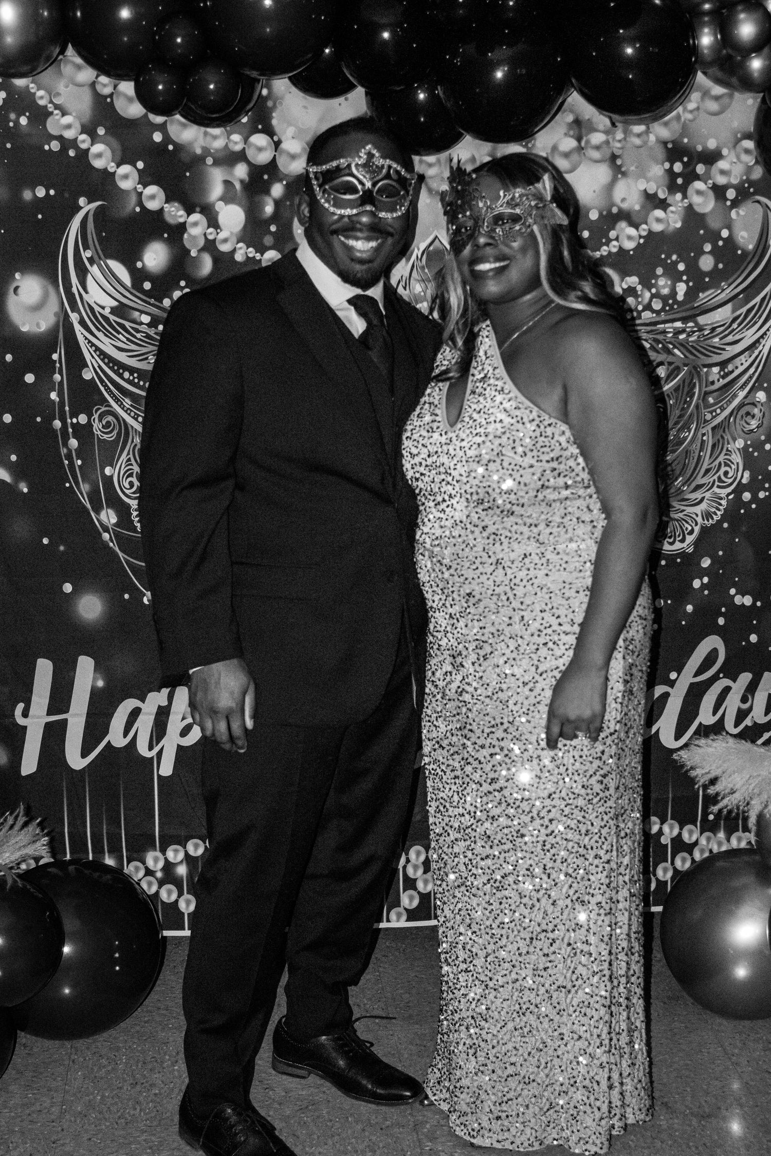 Formal masquerade party with sparkling decorations and elegant attire.