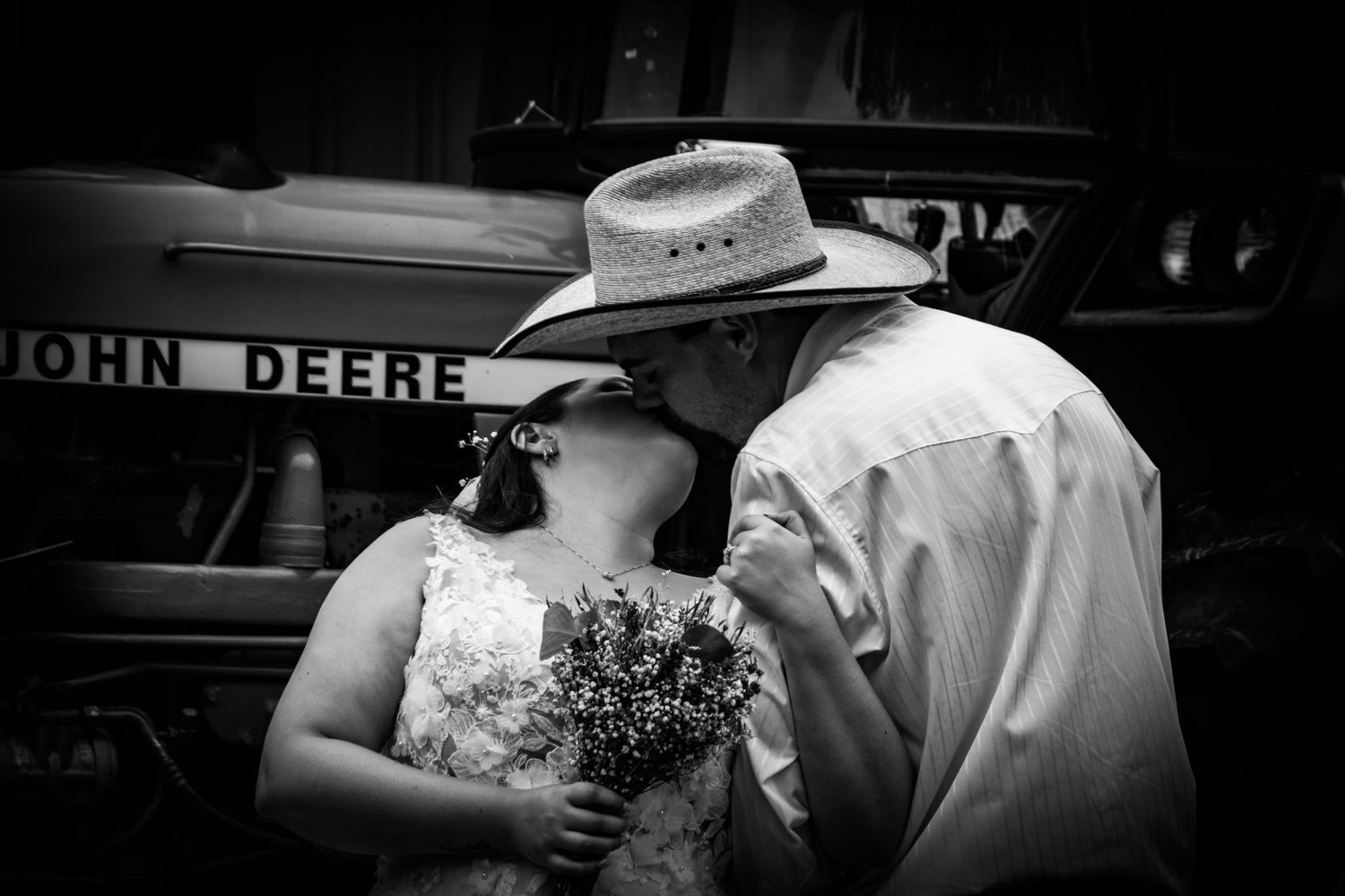 A black and white photo series showing intimate moments between a couple in cowboy hats at a country wedding.