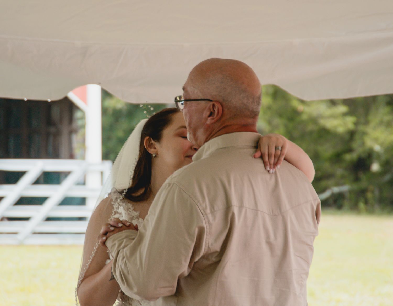 A series of romantic wedding photos showing couples embracing and kissing in an outdoor setting with white fences.