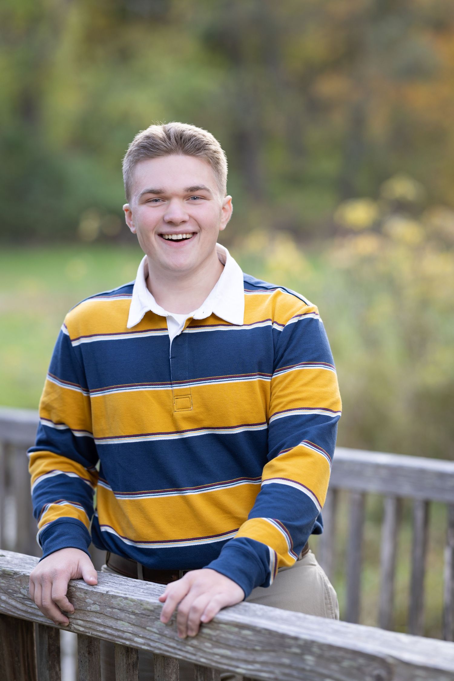 A series of outdoor portrait photos showing someone in a yellow and navy striped rugby shirt against a blurred natural background.