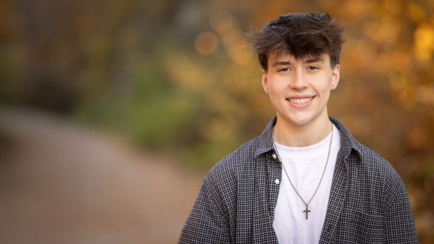 A series of headshots showing the same person in different poses against an autumn background with blurred bokeh effect.