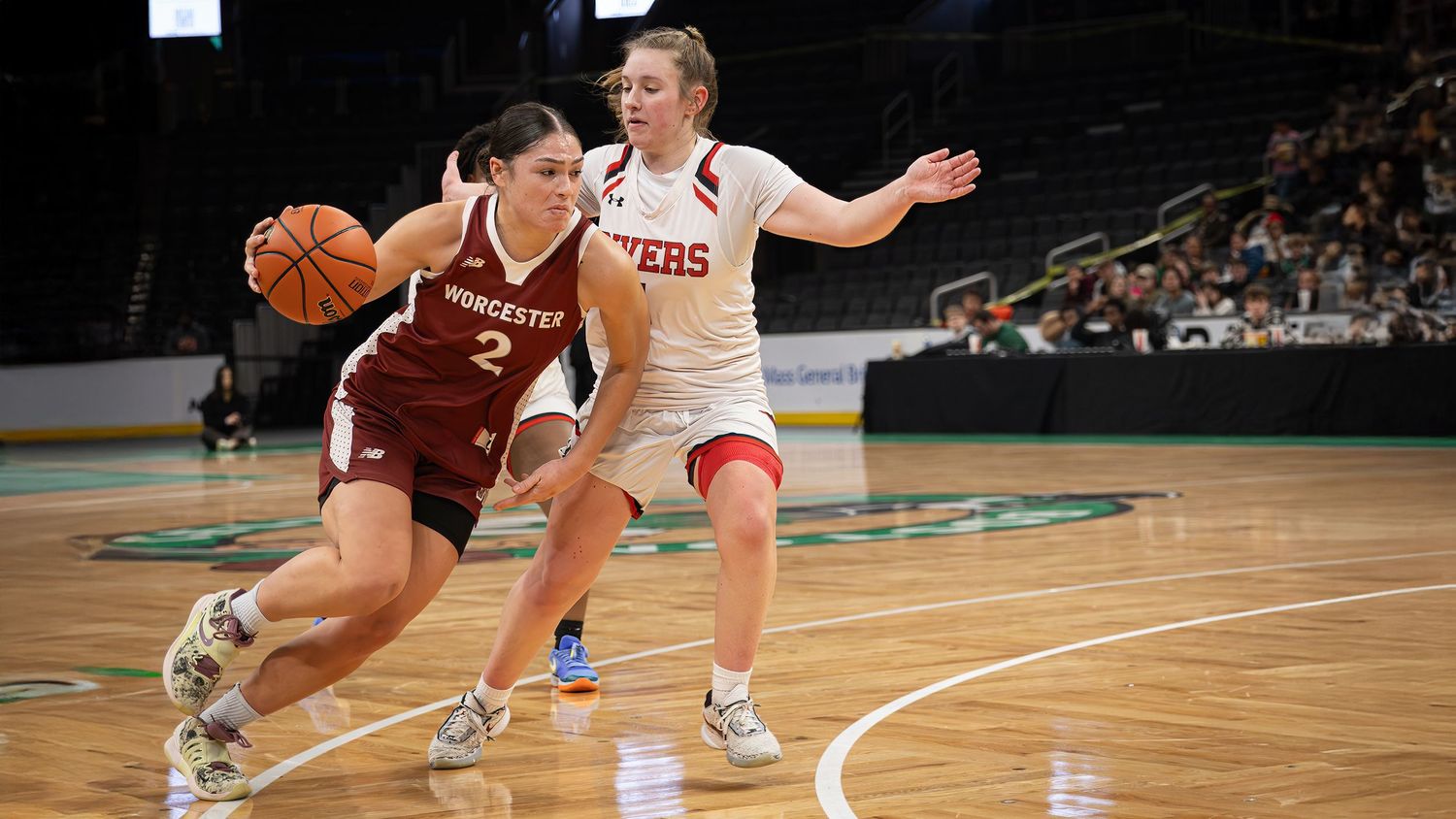 Basketball players compete for possession during an intense game on a professional court.