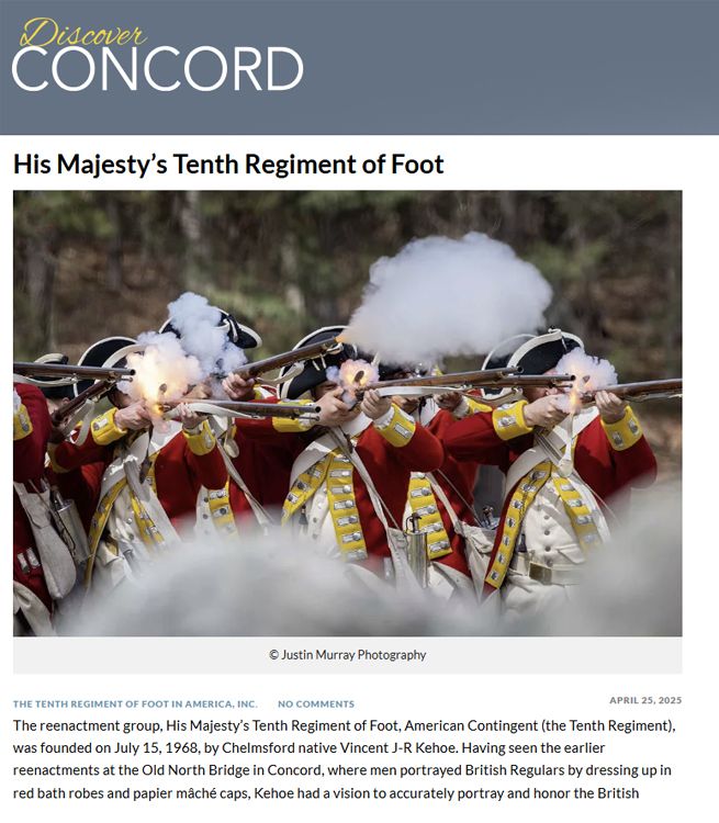 Historical reenactors in British military uniforms fire muskets during a battle demonstration at Concord.