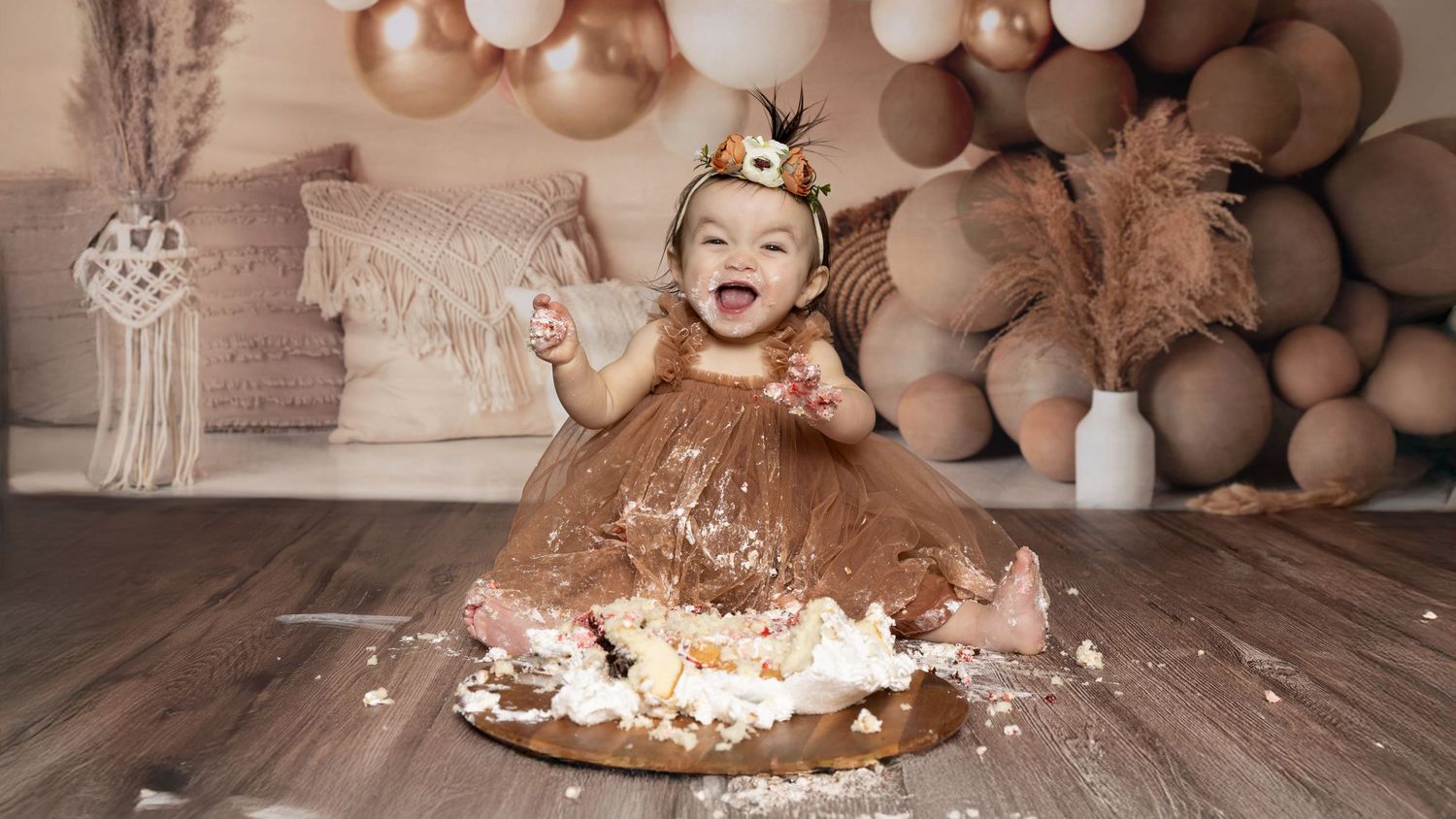 Chocolate cake with white frosting and teddy bears arranged in a rustic setting with warm lighting and party decor.