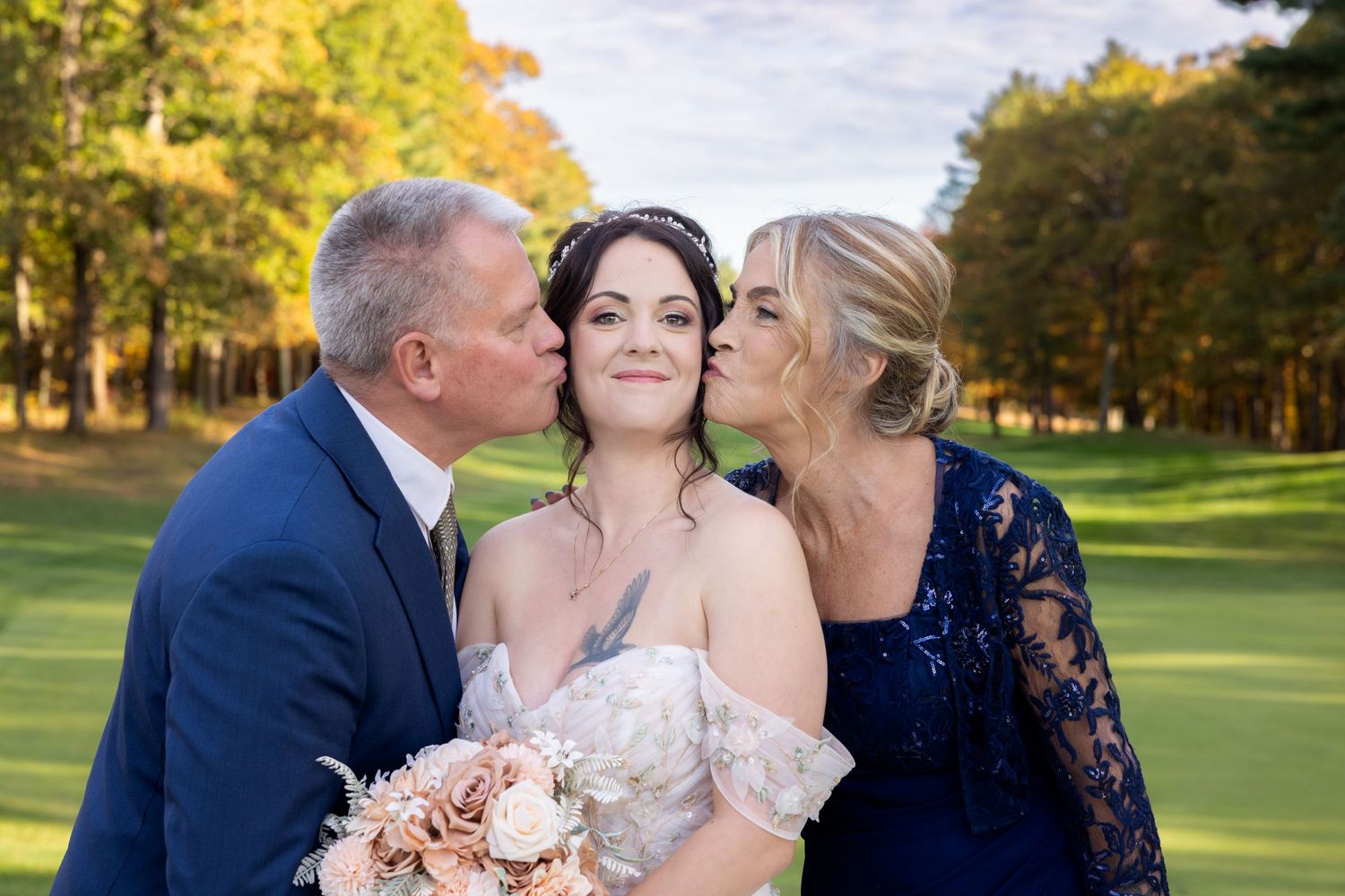 Wedding party shares joyful moments together on a lush golf course during golden hour.