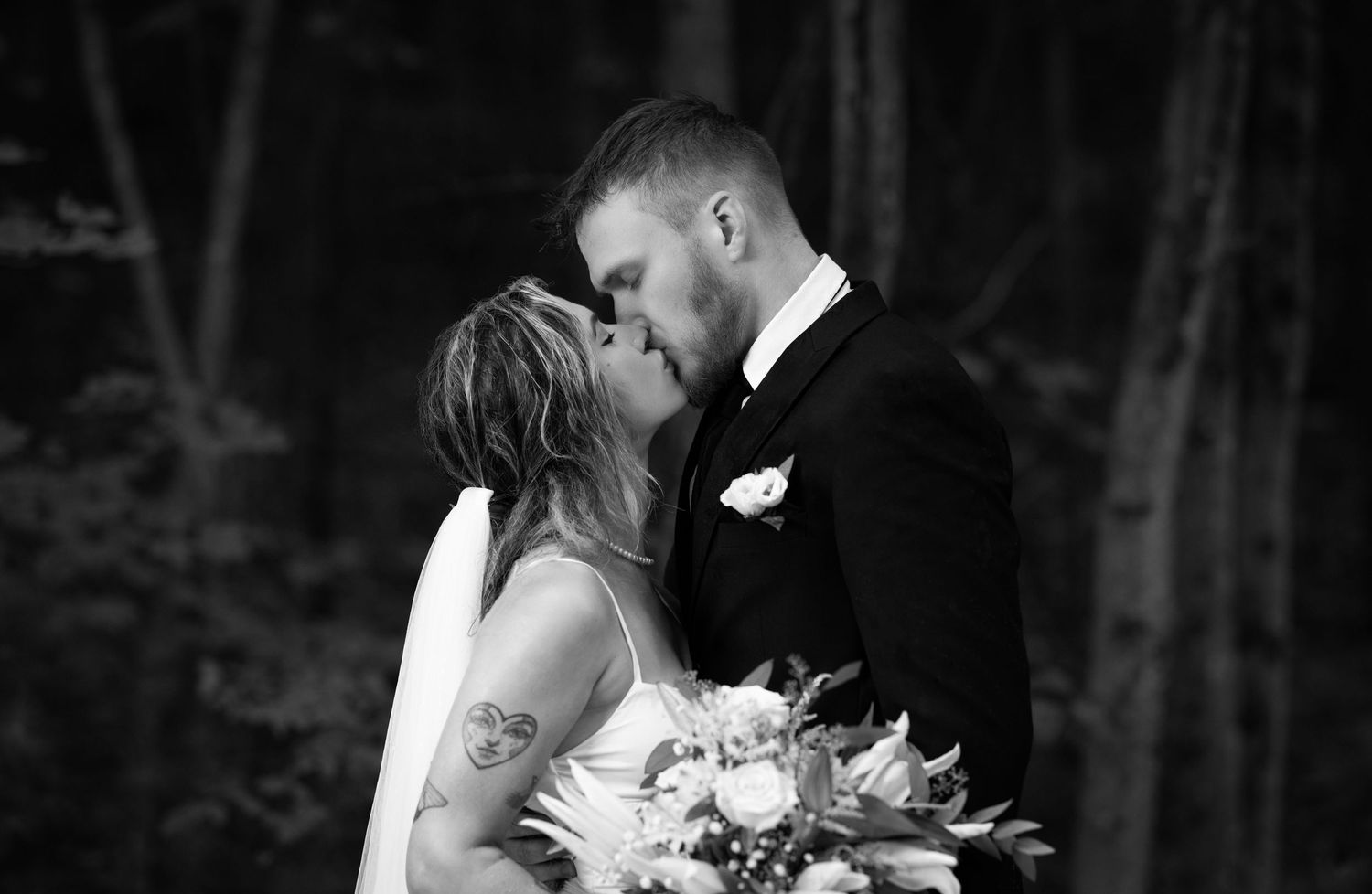 A romantic black and white wedding photo montage showing intimate moments between newlyweds in an outdoor setting.