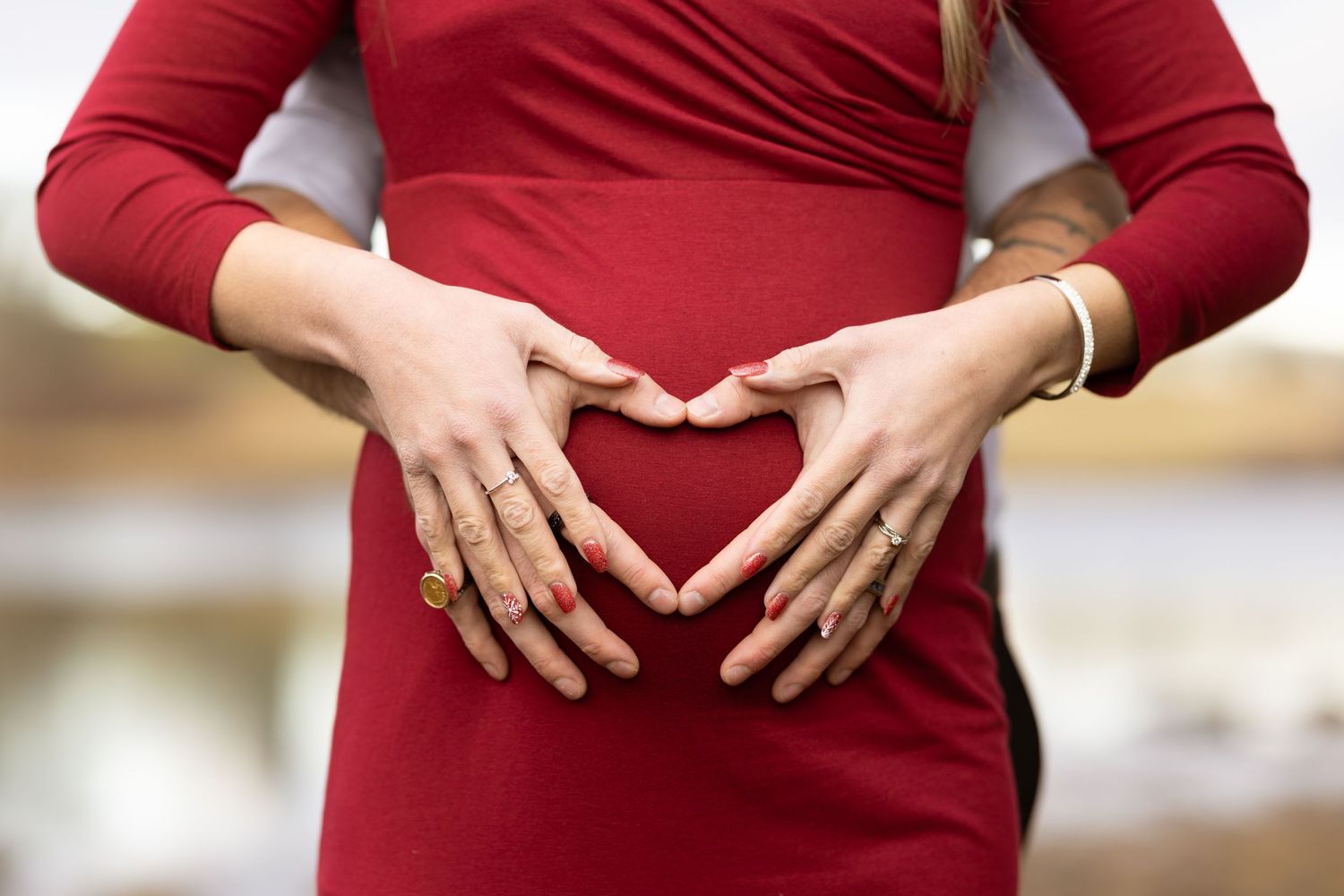 A series of five cropped photos showing hands forming a heart shape gesture against a red dress background.