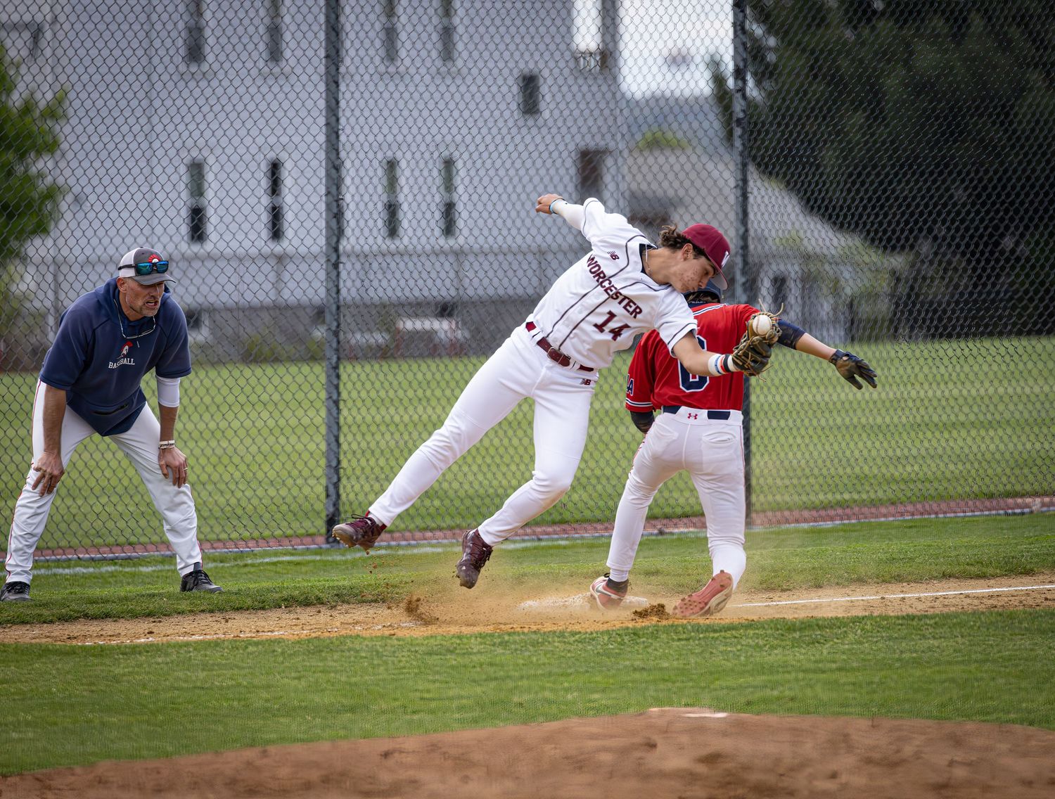 Baseball players execute a sequence of fielding plays during a game on a grass and dirt diamond.