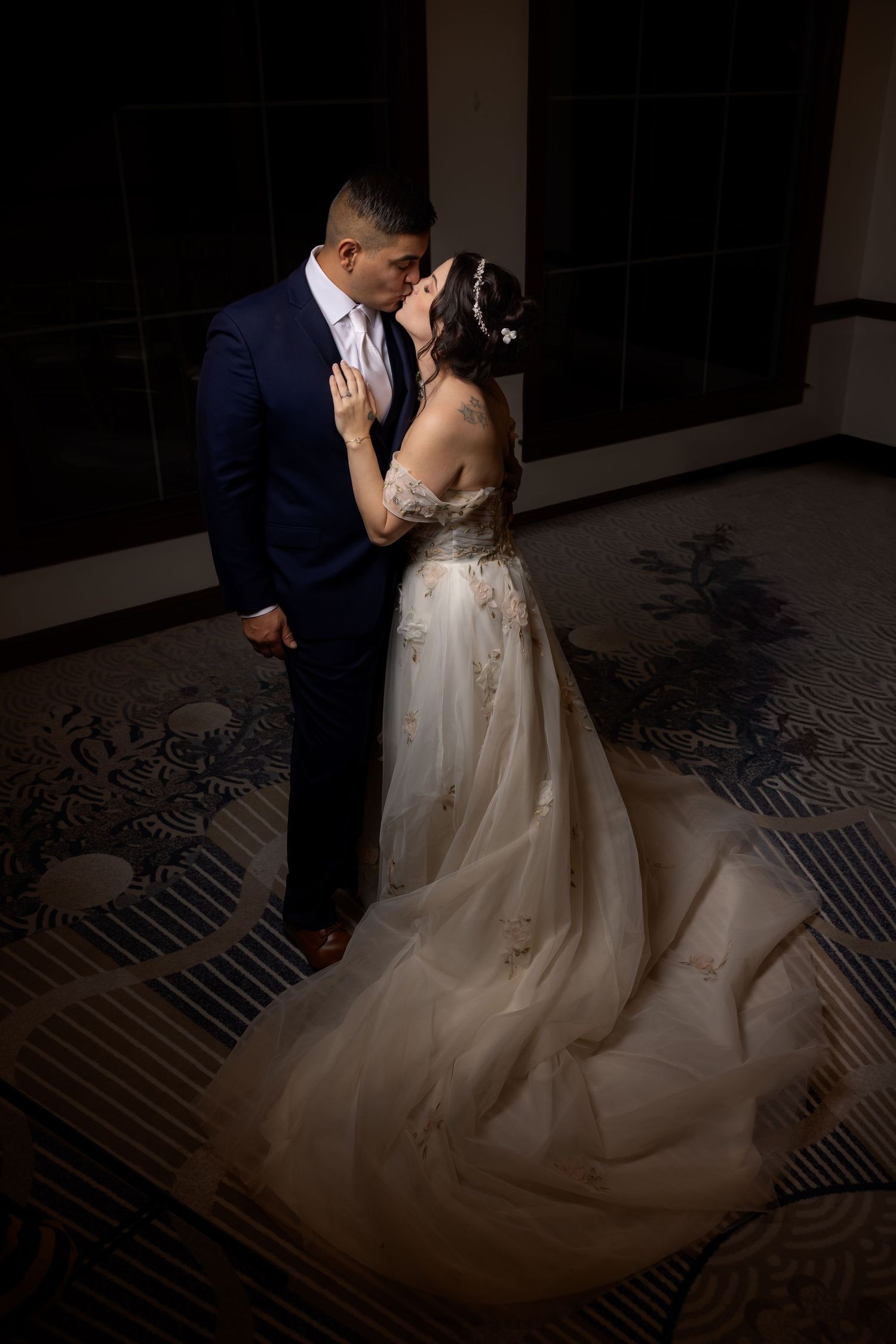 A romantic wedding dance sequence showing a couple twirling in an elegant ballroom with a patterned floor.