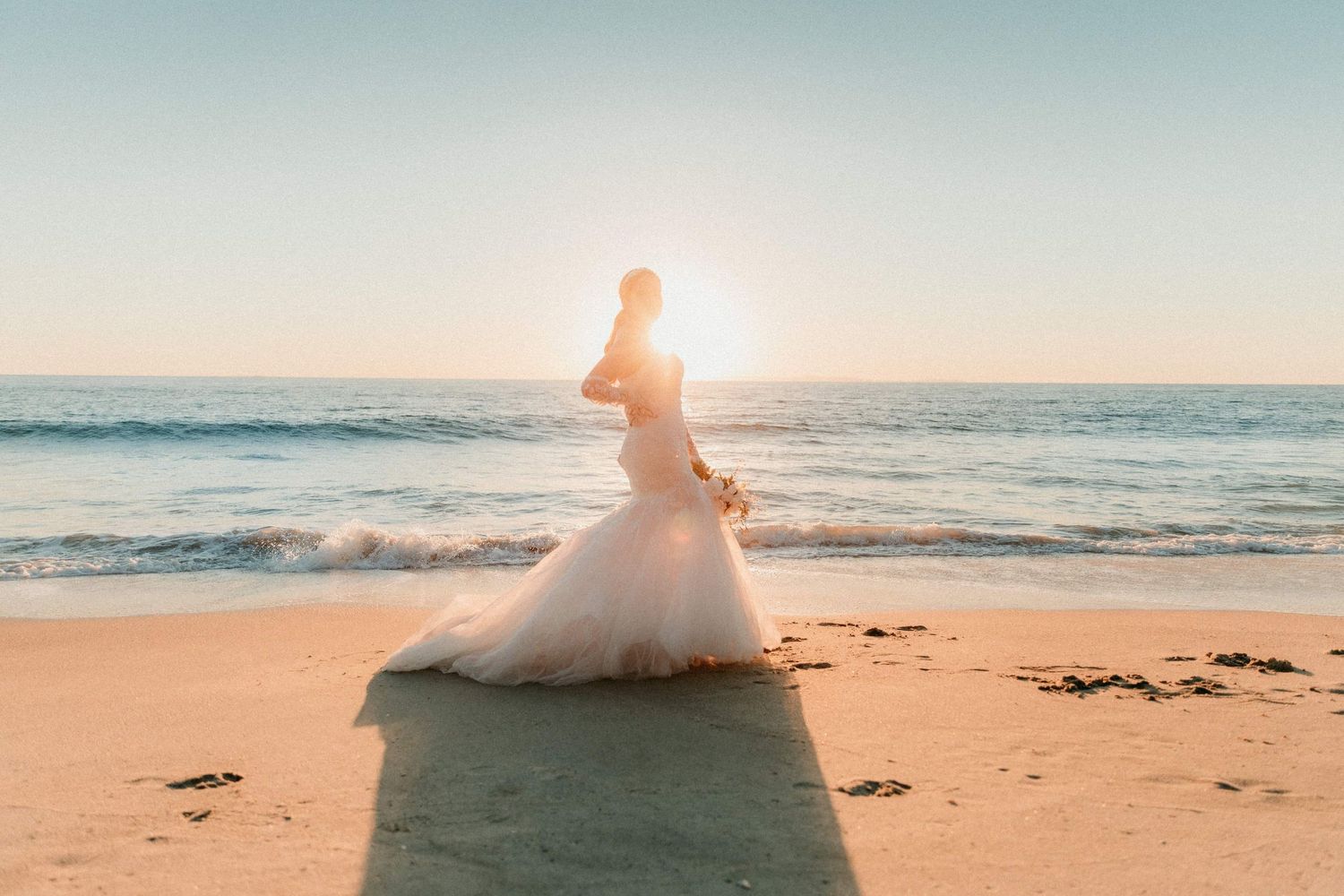 Bride in golden light on California beach photographed by Magnolia Events & Photography