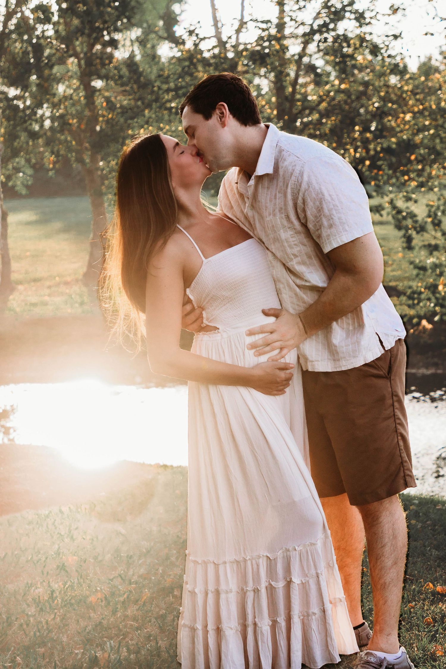 Expecting couple celebrating pregnancy announcement during portrait session
