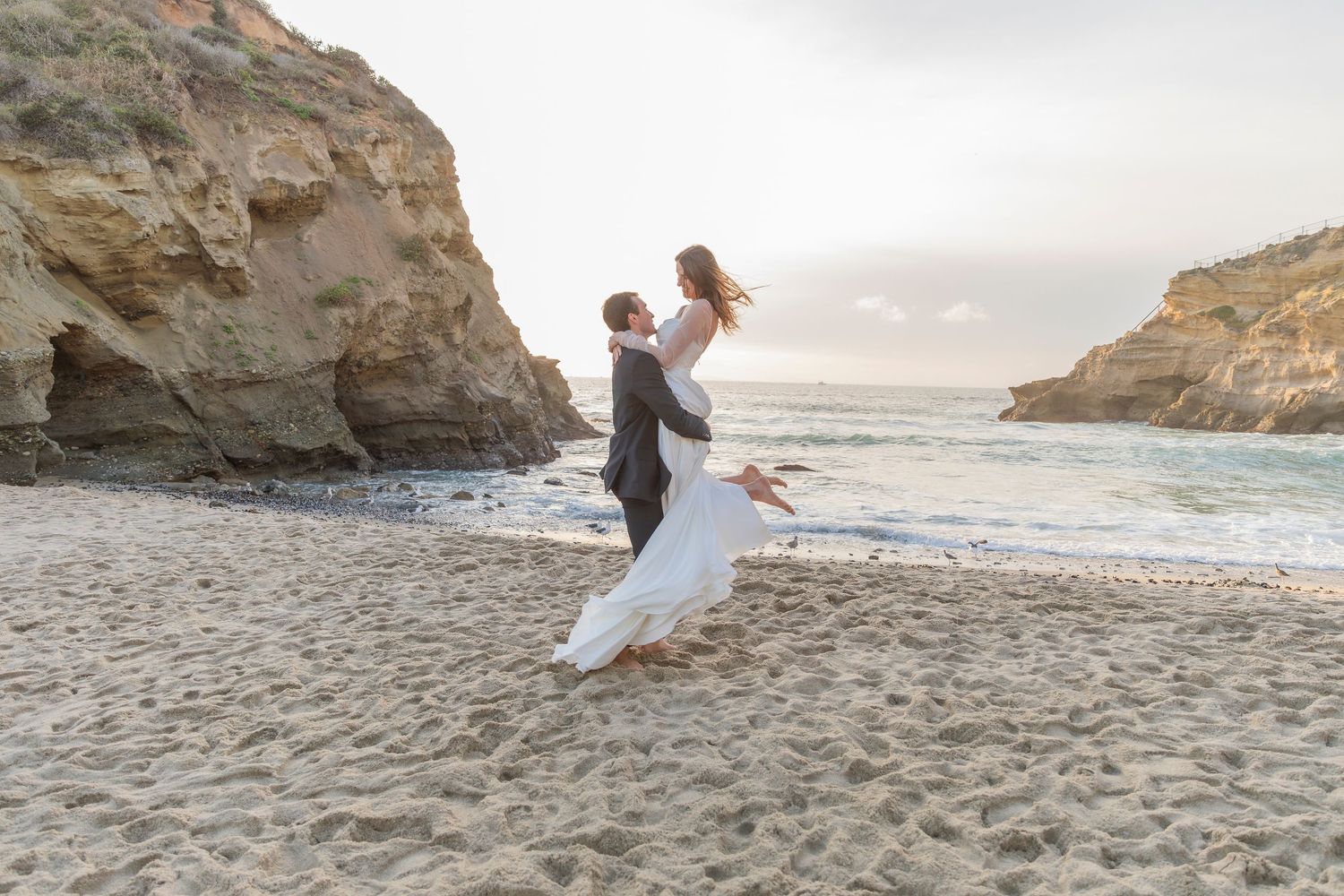 Bride and groom in front of the ocean photographed by Magnolia Events & Photography