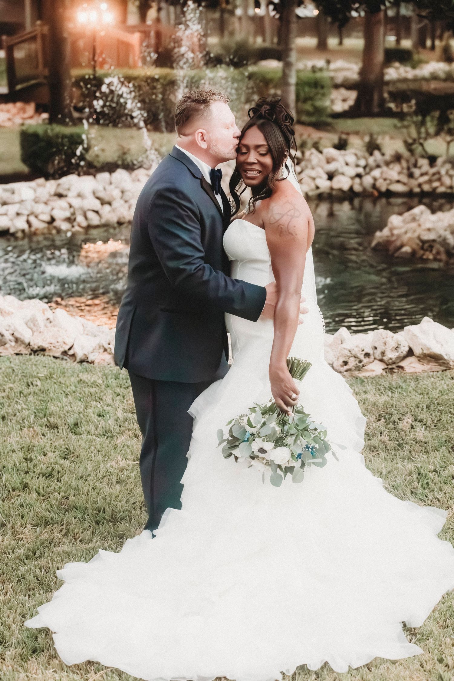 Newly married couple embracing during wedding portraits captured by Magnolia Events & Photography