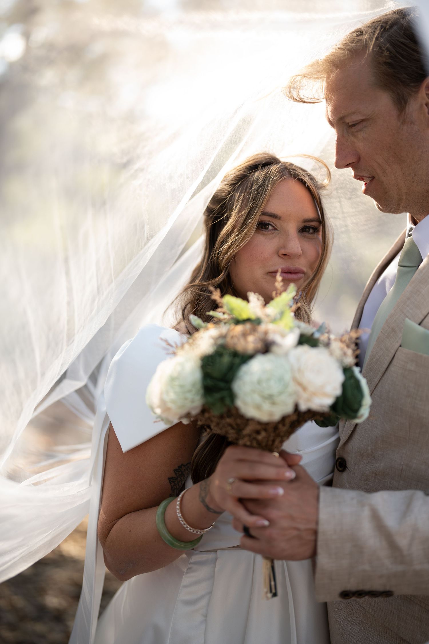 Carmel Valley Wedding A romantic wedding moment captured in a series of five photos showing tender interactions with a bridal bouquet.