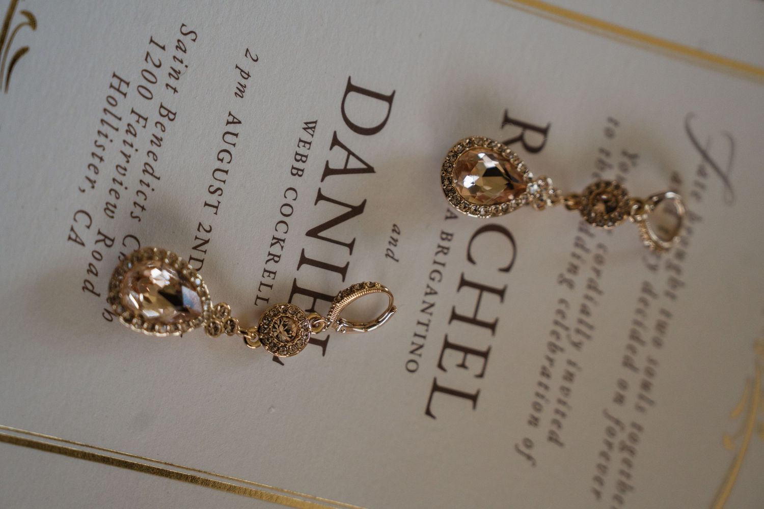 Close-up of elegant gold-trimmed wedding invitation with classic typography.