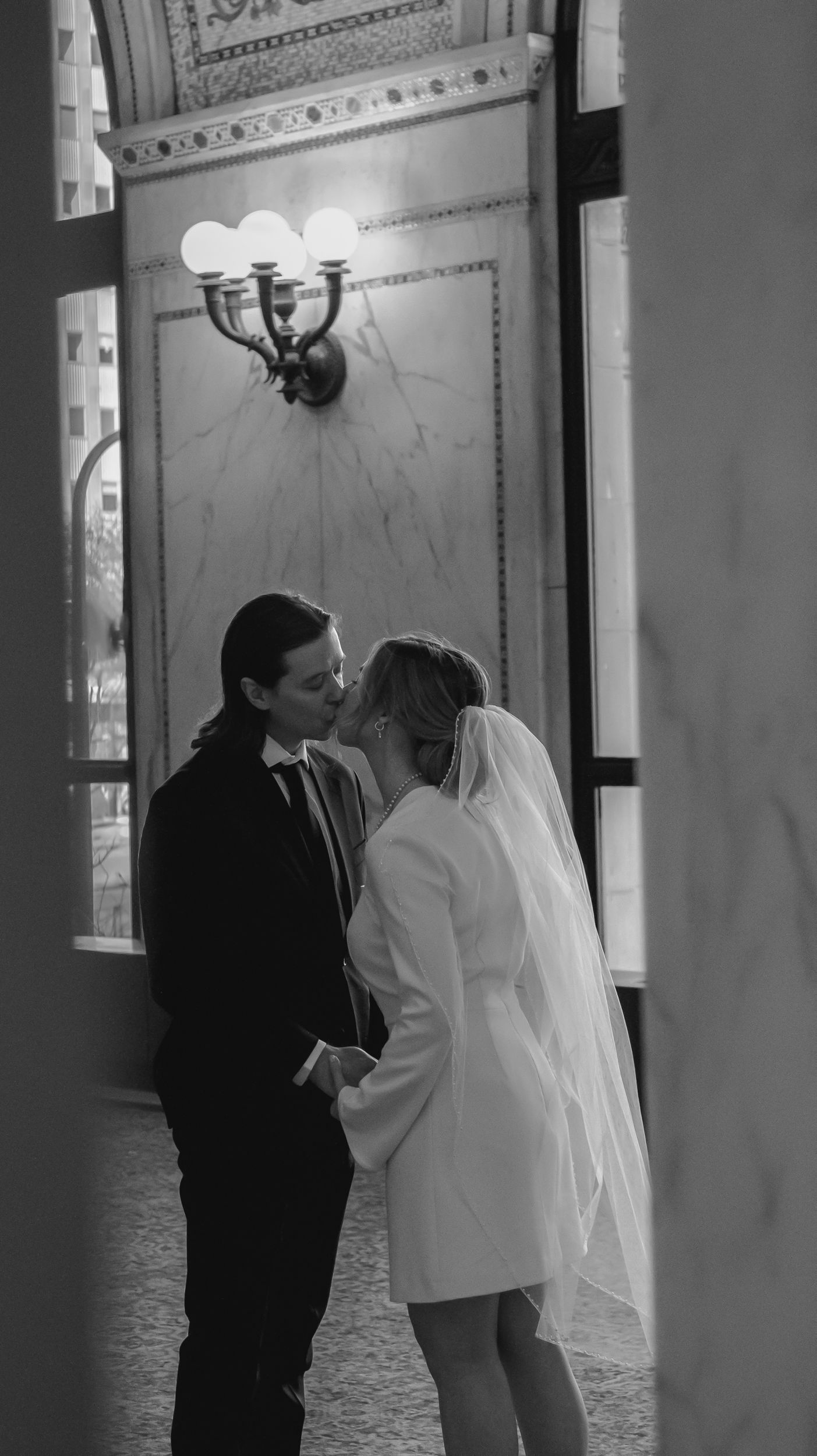 Bride and groom share a kiss inside the Chicago Cultural Center during a courthouse wedding ceremony.
