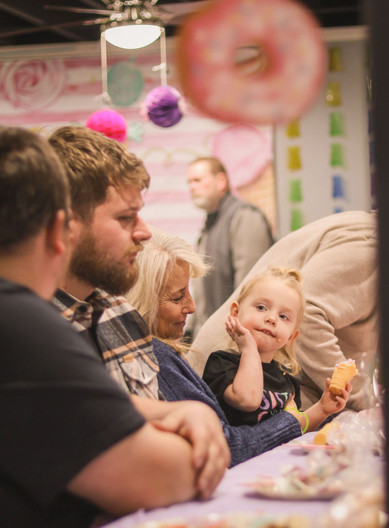 Big sister sits with family at birthday party