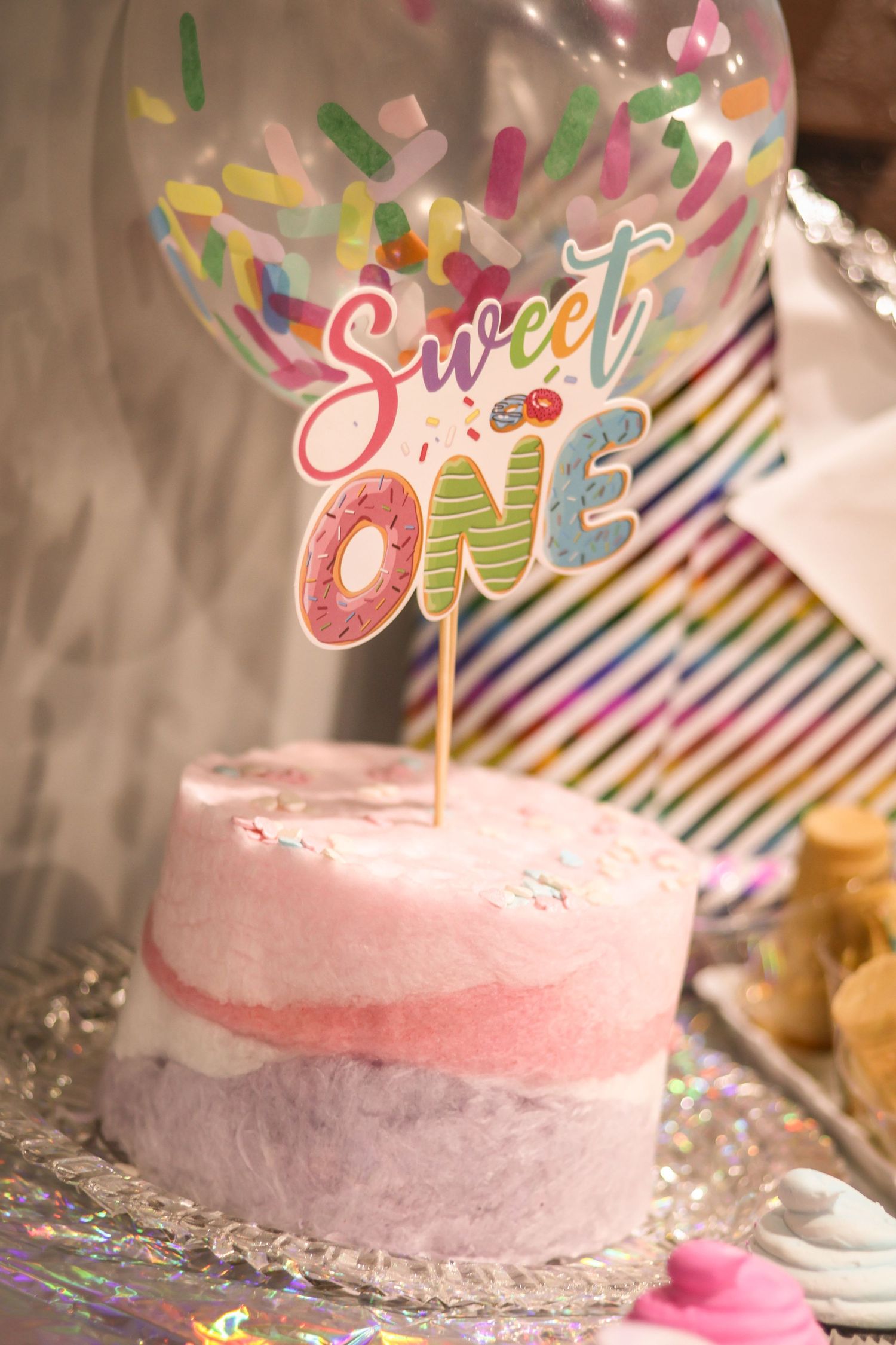 Cotton Candy birthday cake with cake topper that says 