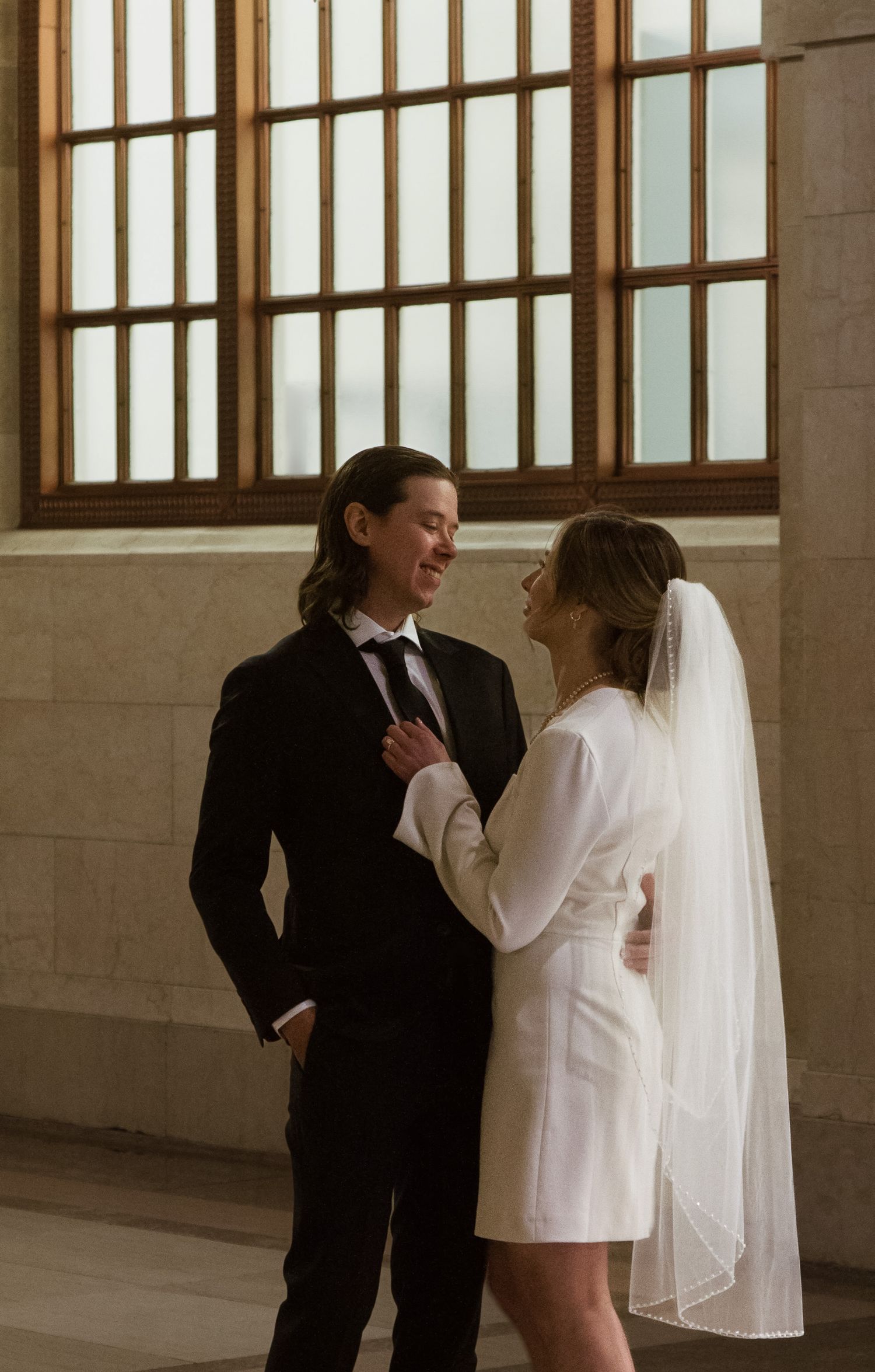 Groom and Bride hold each other close and lovingly look into each others eyes in Chicago after elopement
