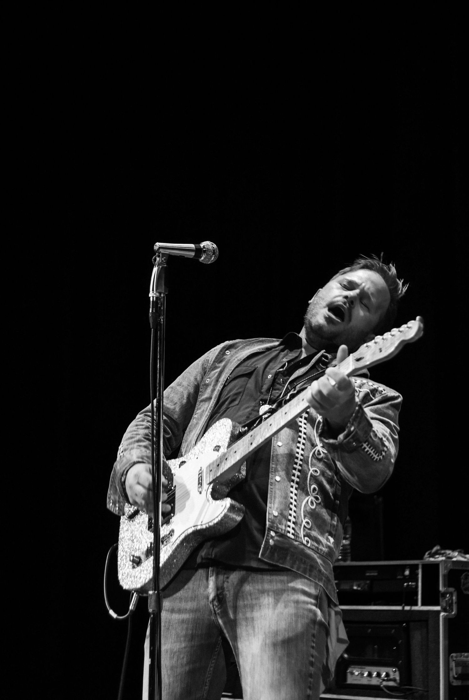 Lead singer of the band Iron Horse plays his guitar with a lot of emotion, photo in black and white