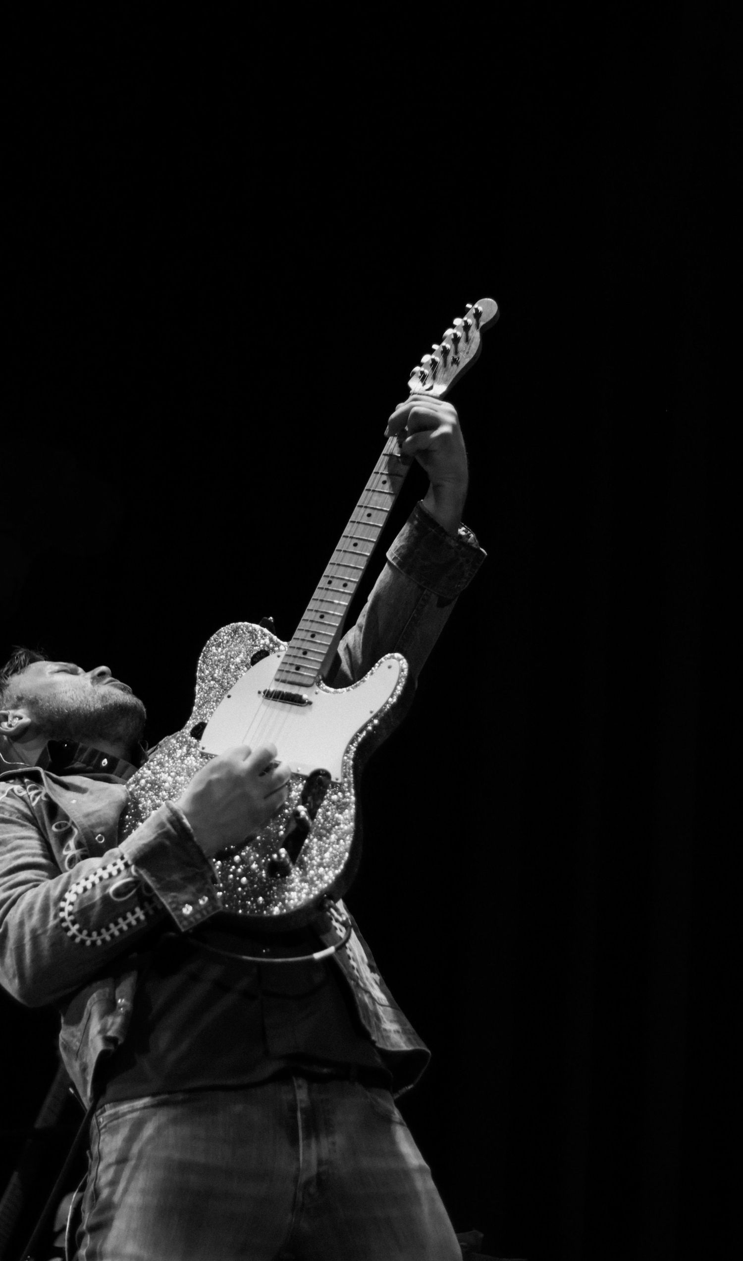 Live music event photography in Chicago by Kristin Photo Co. Lead Guitar player leans back and plays guitar