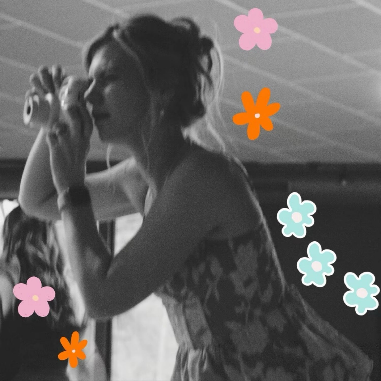 Photo of Kristin holding camera and taking photo. photo in black and white