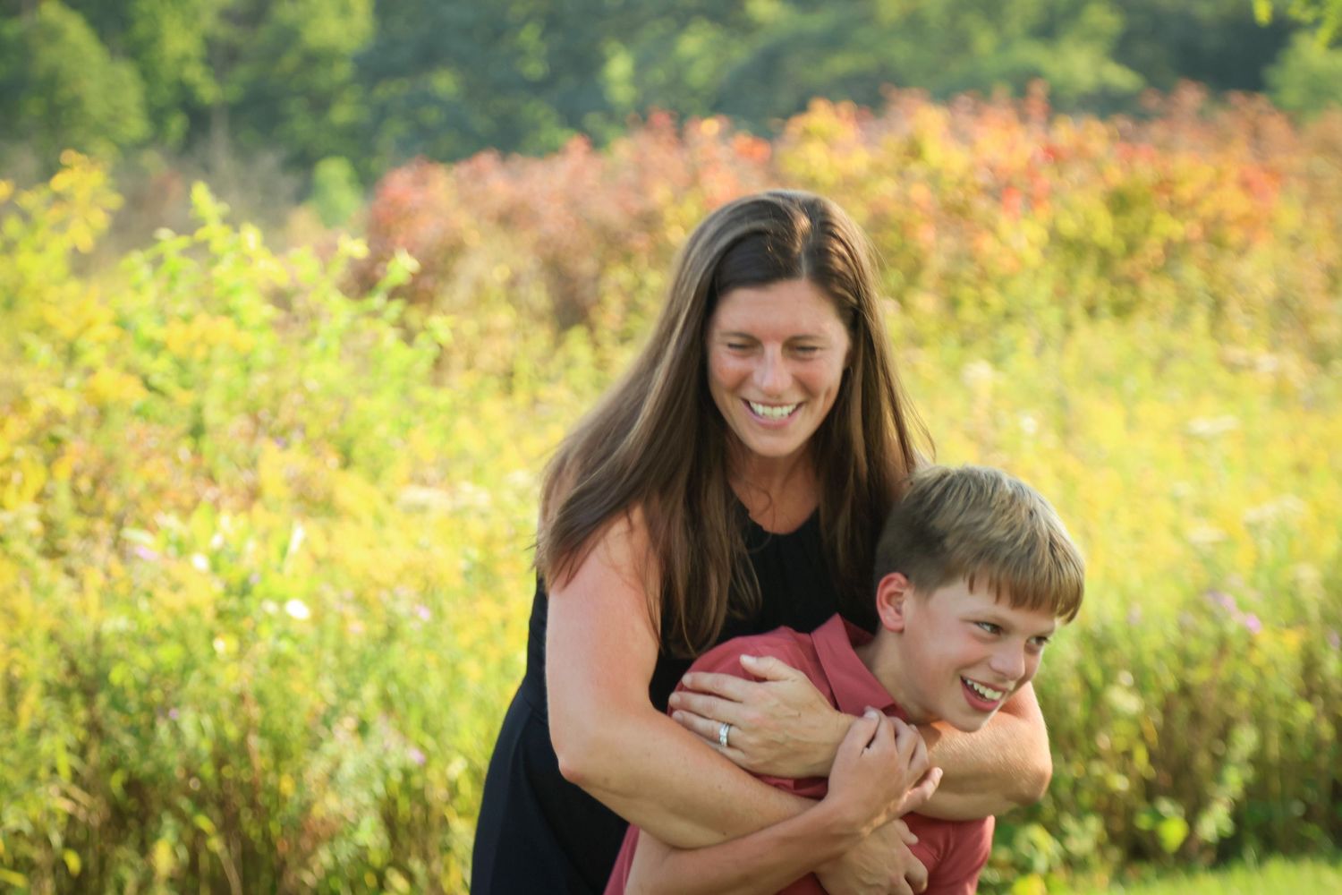 Mother and son hug and sway together while laughing together photo taken at Goodnow Grove in Beecher IL