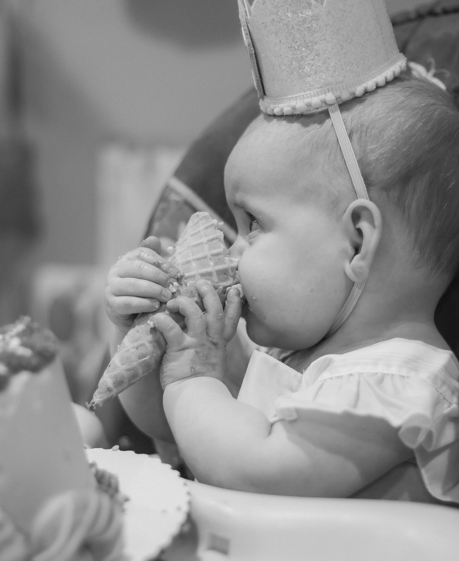 First birthday party photography in Beecher Illinois . photo is black and white as baby eats ice cream cone