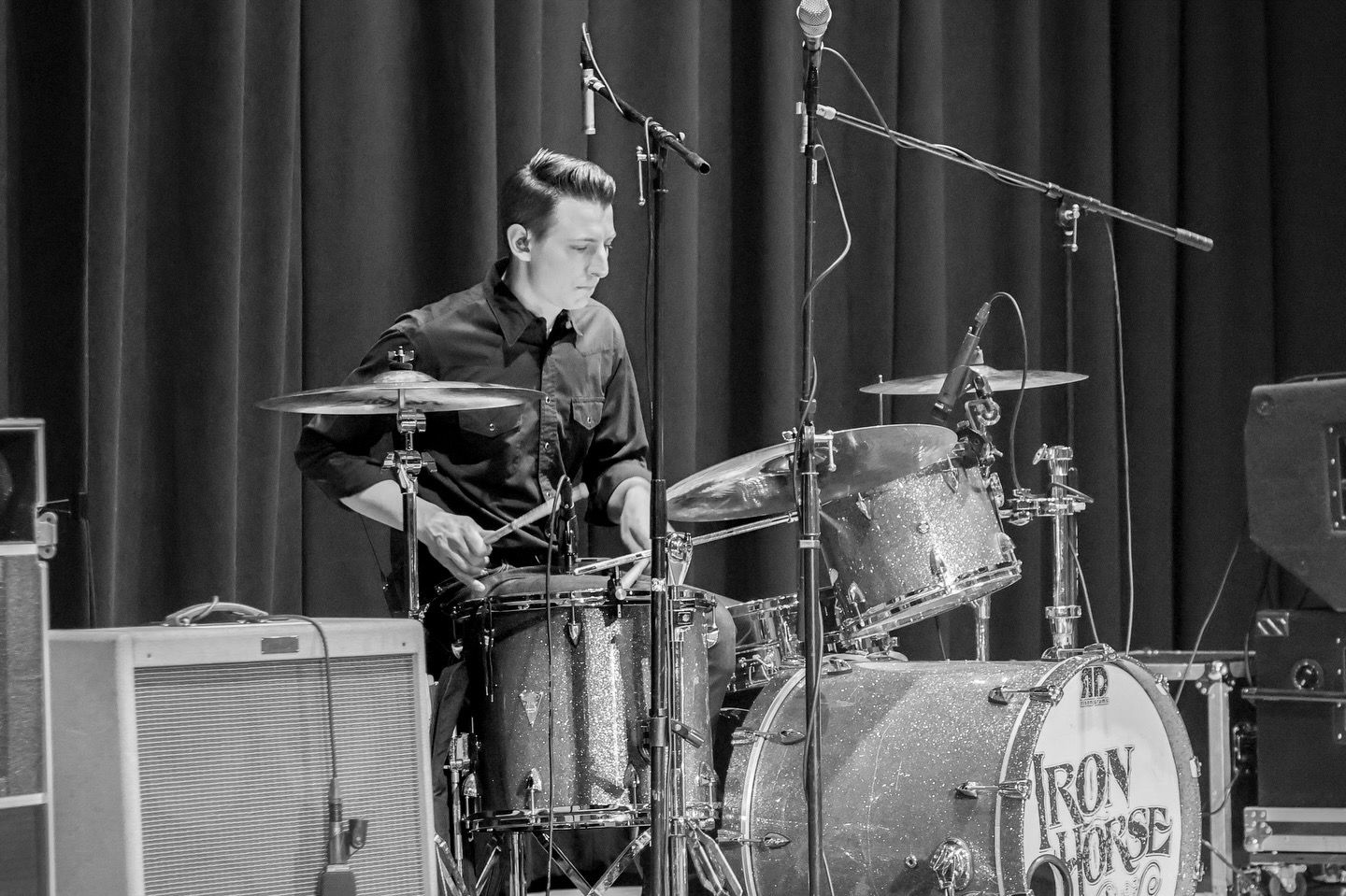 Drummer of the band Iron Horse plays drums in black and white photo
