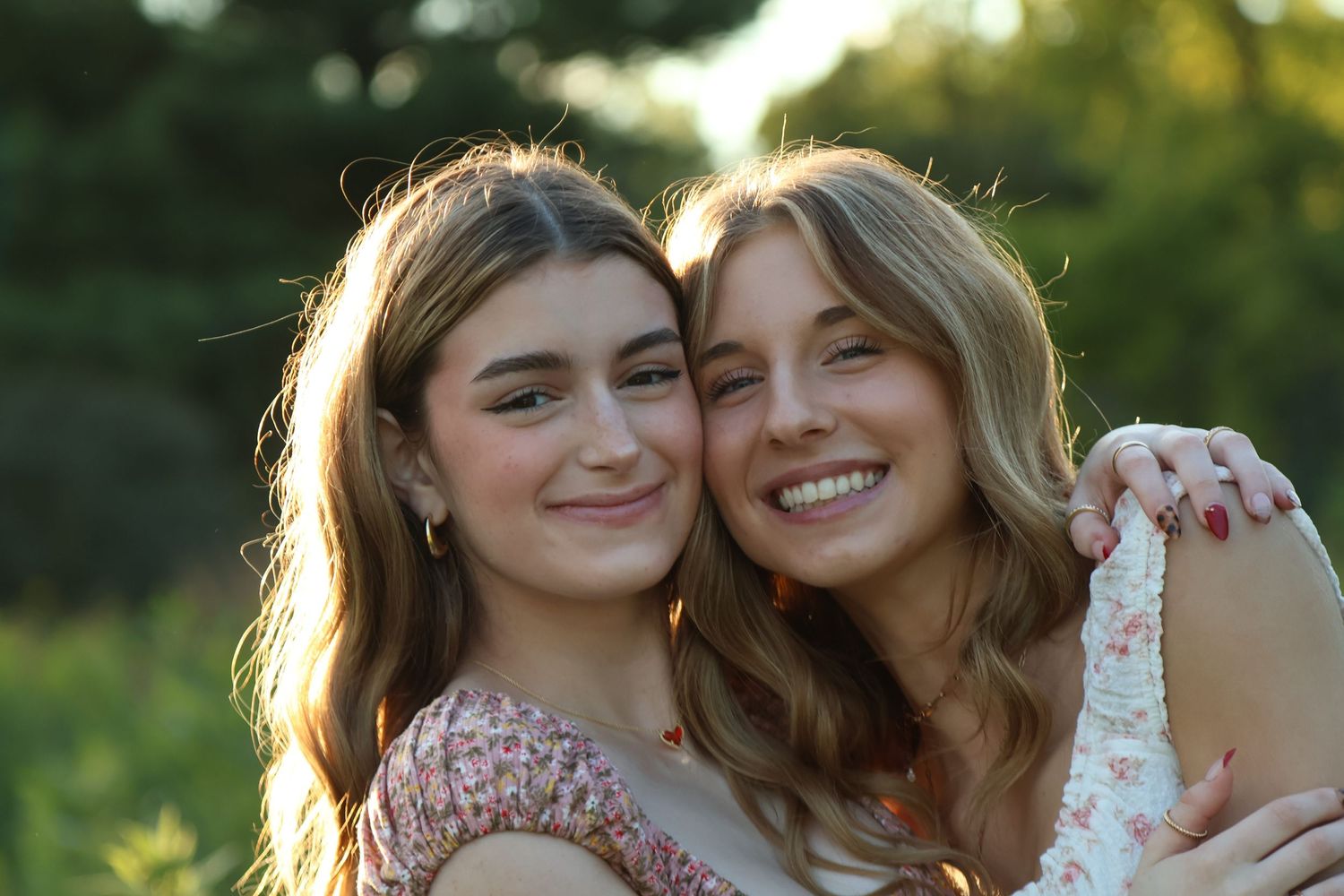 Two senior girl best friends hugging and a close up of their faces with big smiles together
