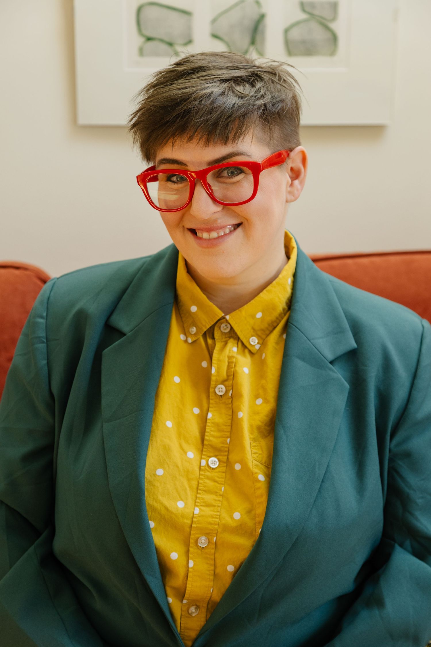A series of five photos showing someone in a bright yellow shirt and teal blazer with red glasses.