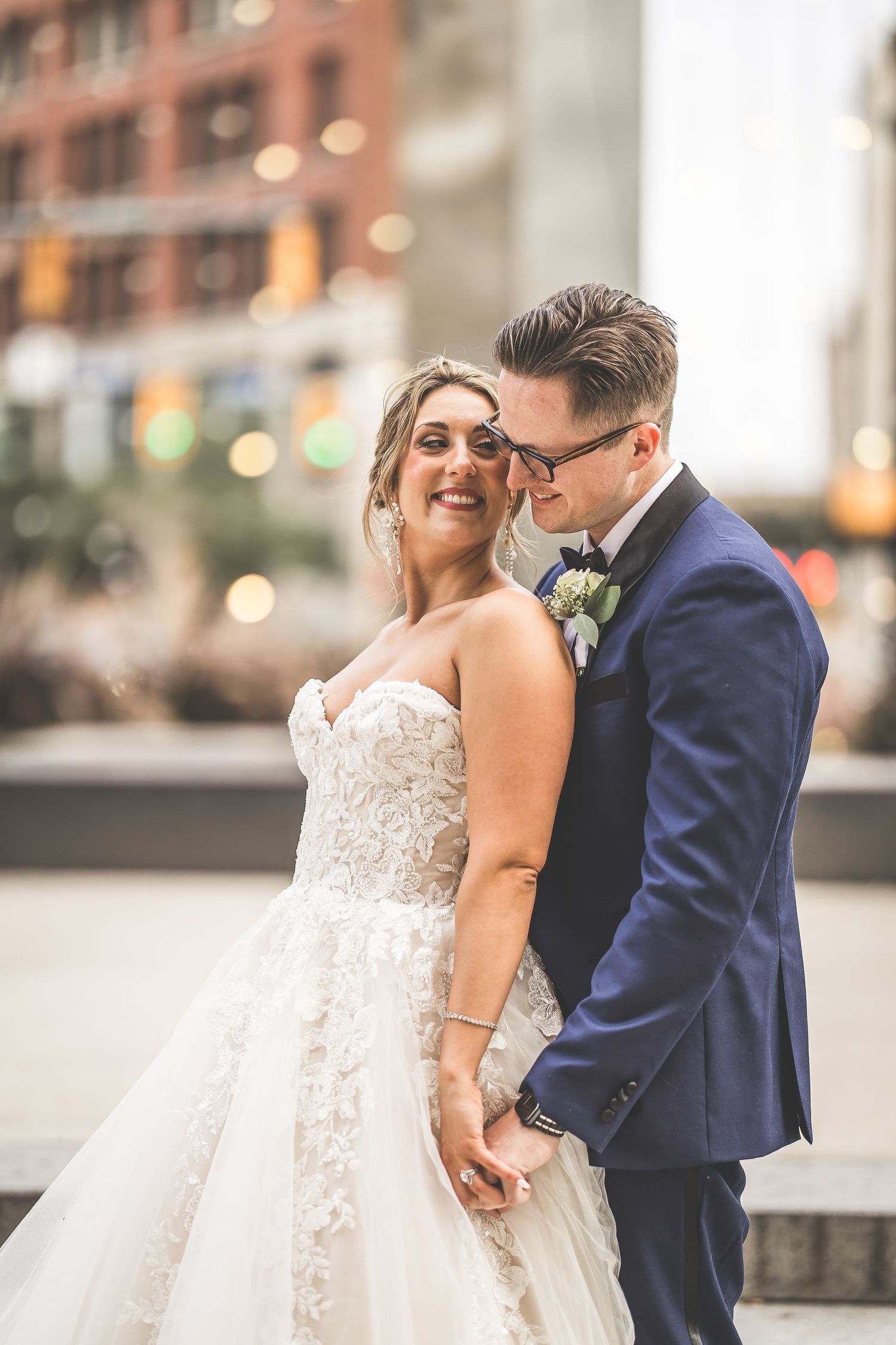 Romantic wedding portrait sequence showing tender moments between newlyweds in urban setting.