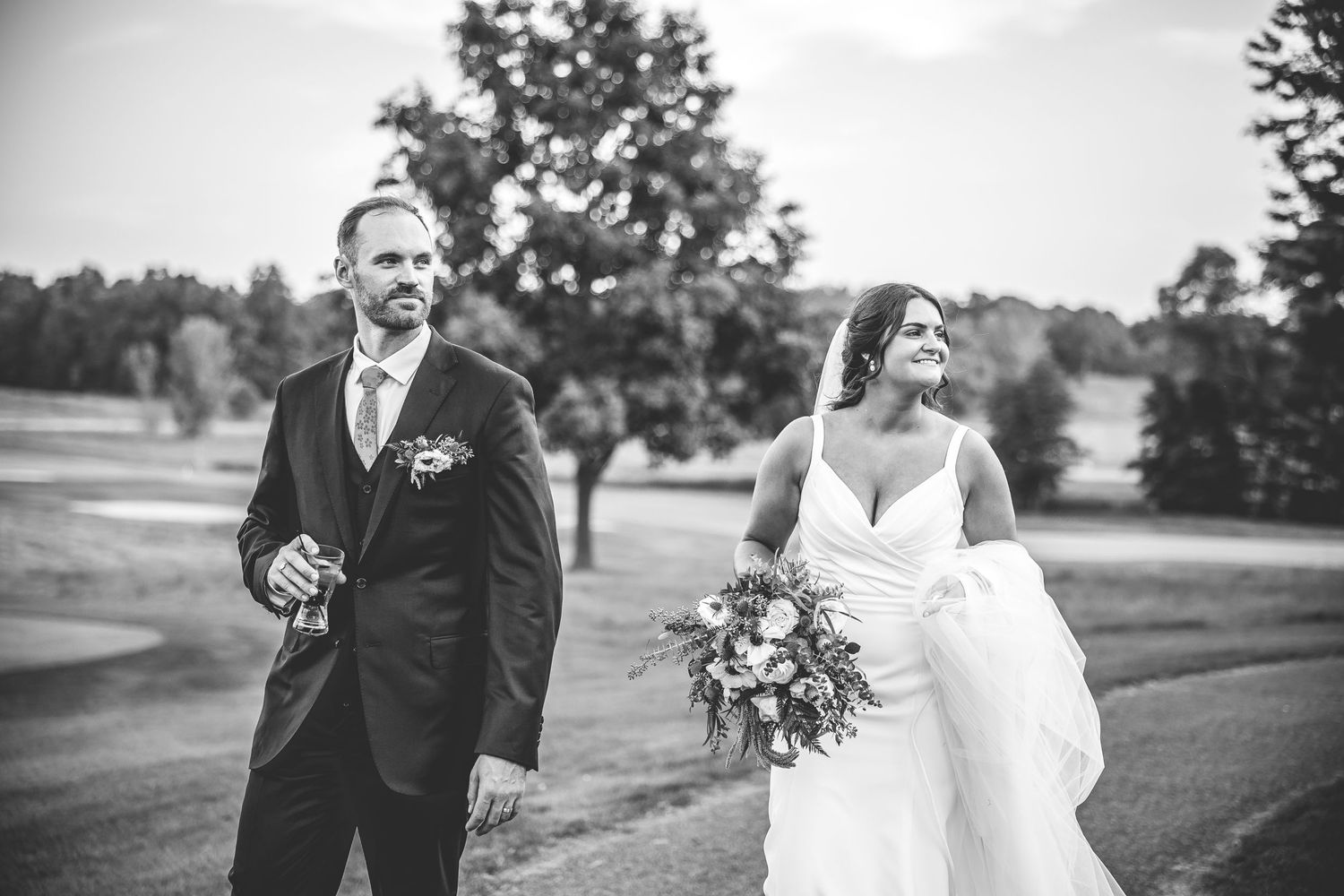 A romantic wedding photo shoot in a scenic outdoor garden setting at sunset.