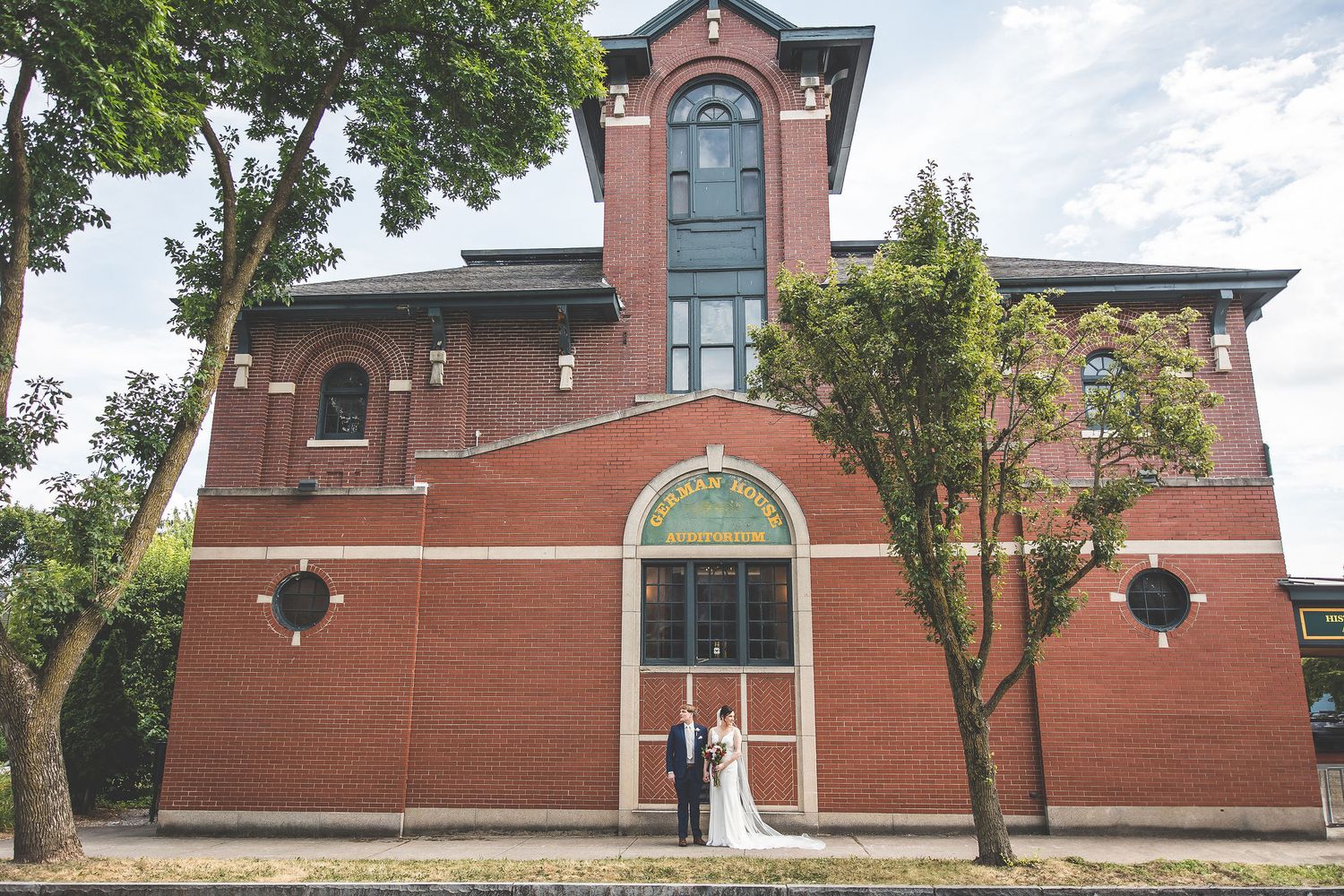 Historic brick building exterior with classic architectural details and landscaping.