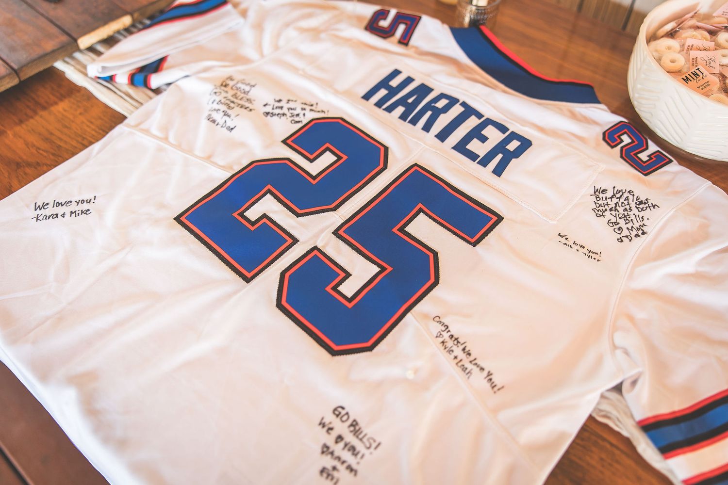 White sports jersey with number 25 and 'HARTER' displayed as wedding guest book.