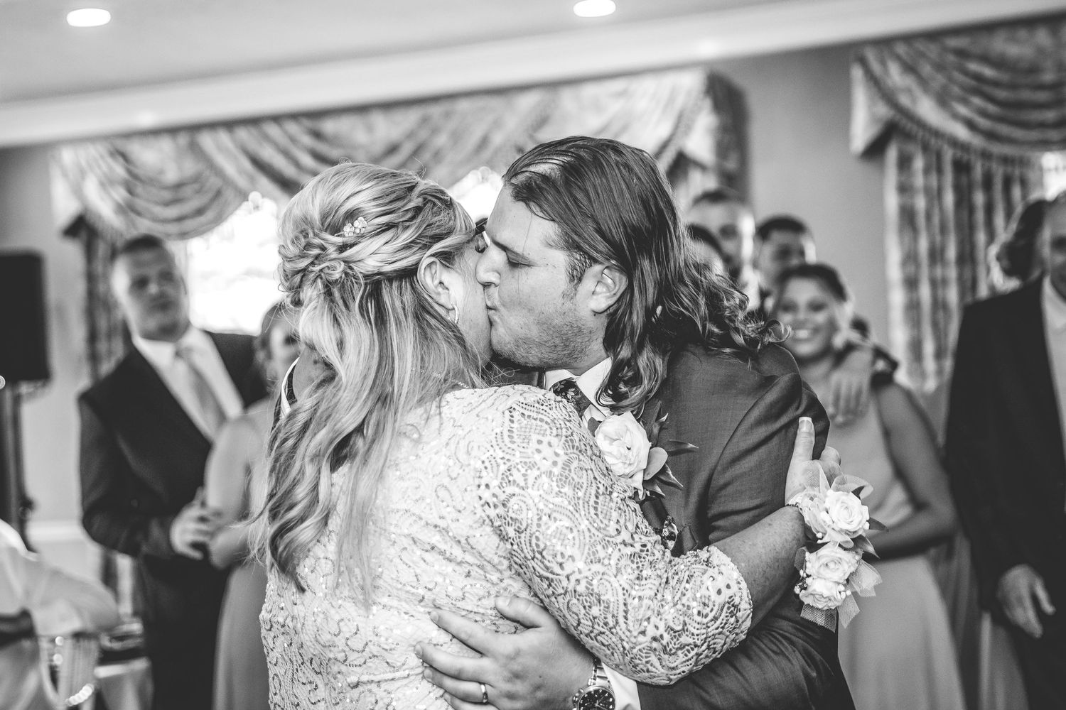 Wedding party dances and celebrates in a beautifully decorated reception venue.