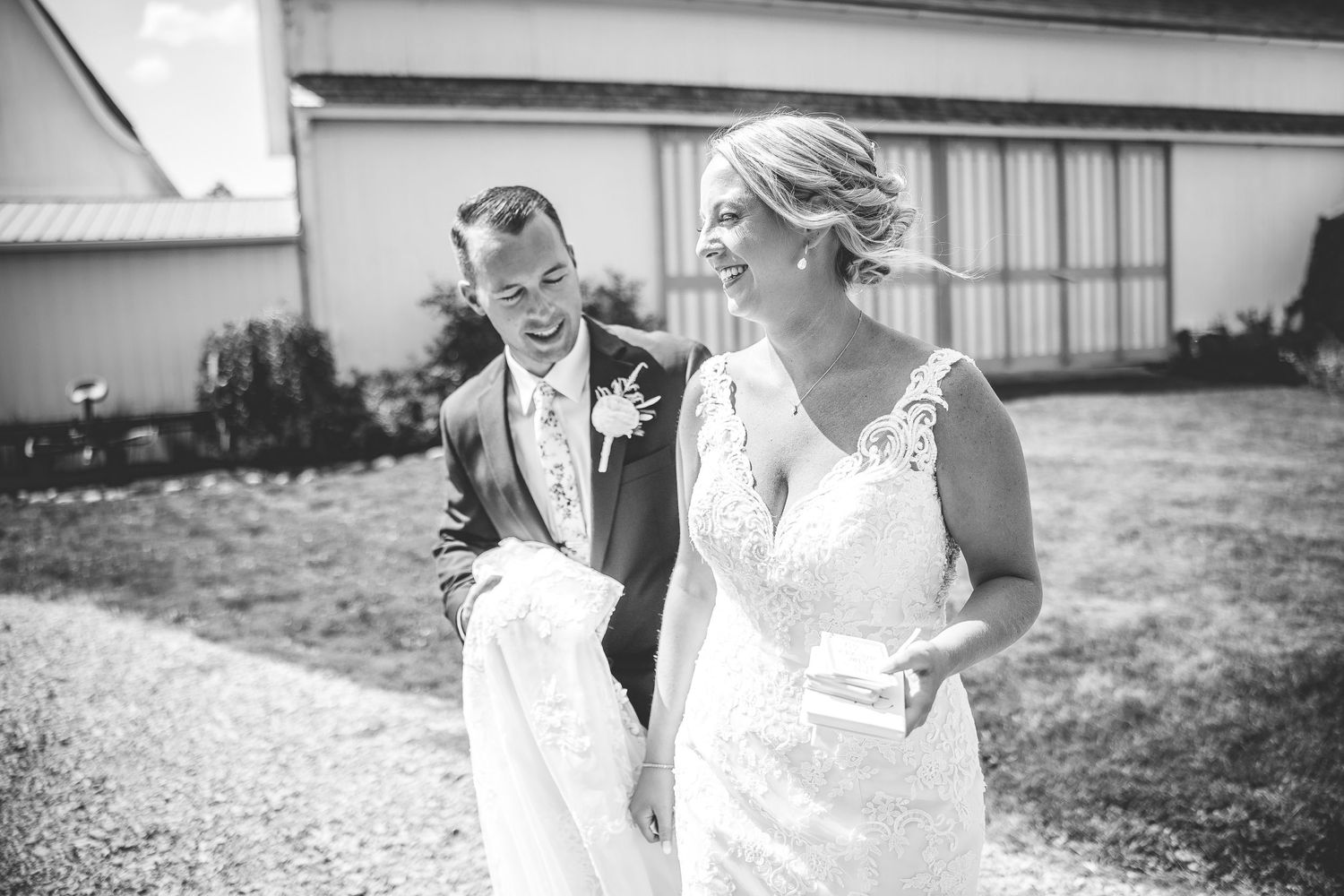 Black and white wedding photography capturing joyful moments between a couple outdoors.