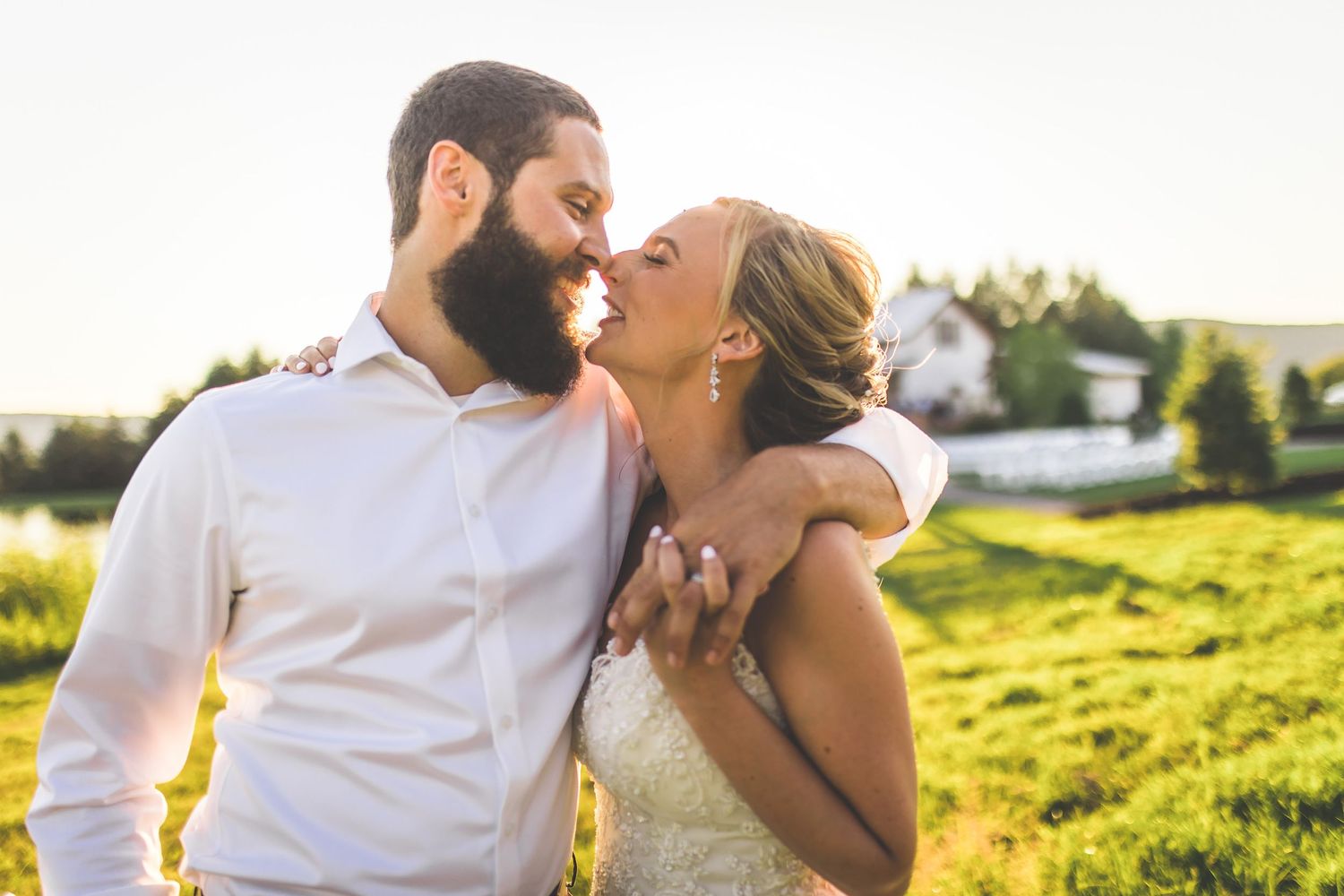 A romantic sunset photo session in a golden meadow with mountains in the background.
