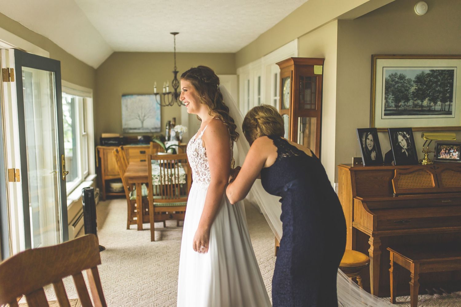 Wedding preparation scene in a home interior with dress and natural lighting.