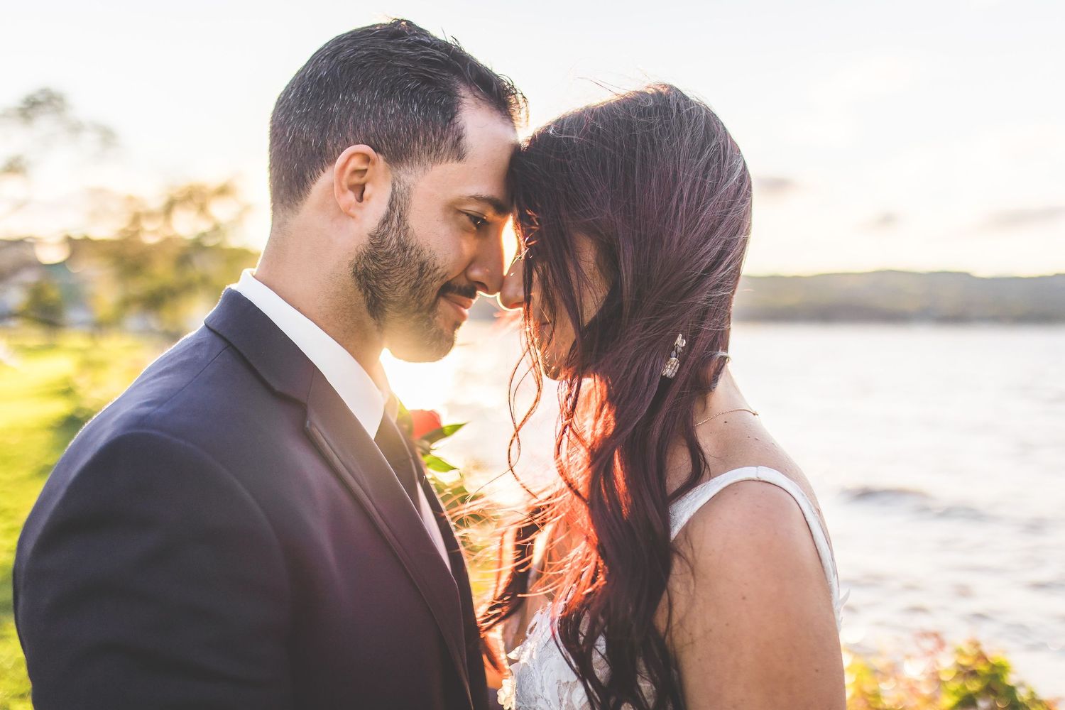 Sunset wedding portraits captured along scenic coastal shoreline.