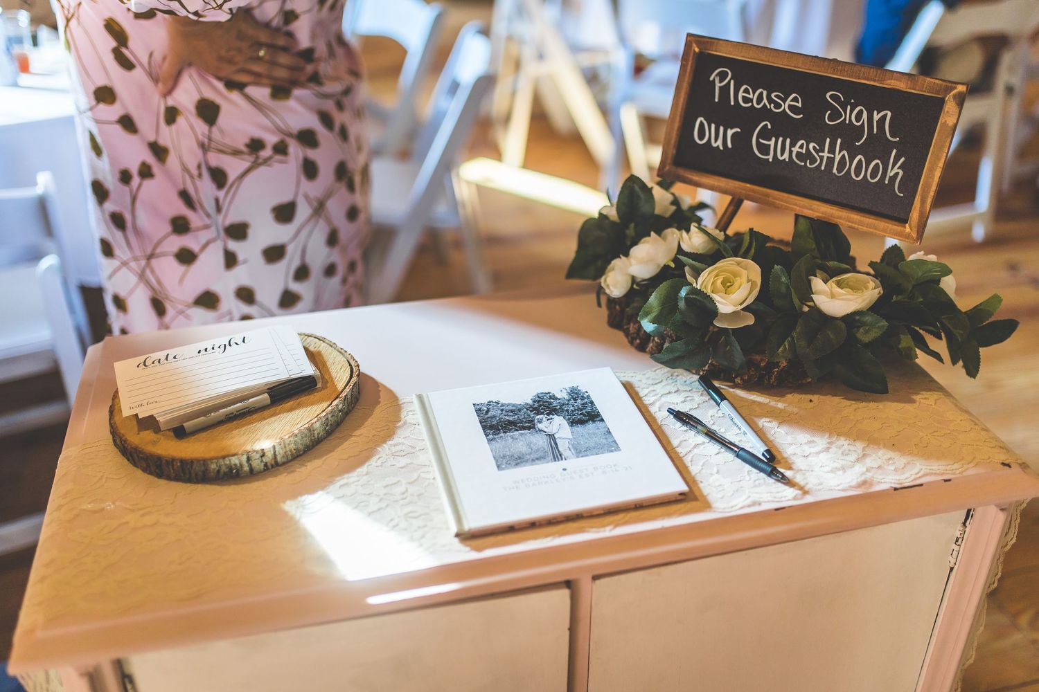 Wedding reception details with rustic wooden signs and decorative elements.