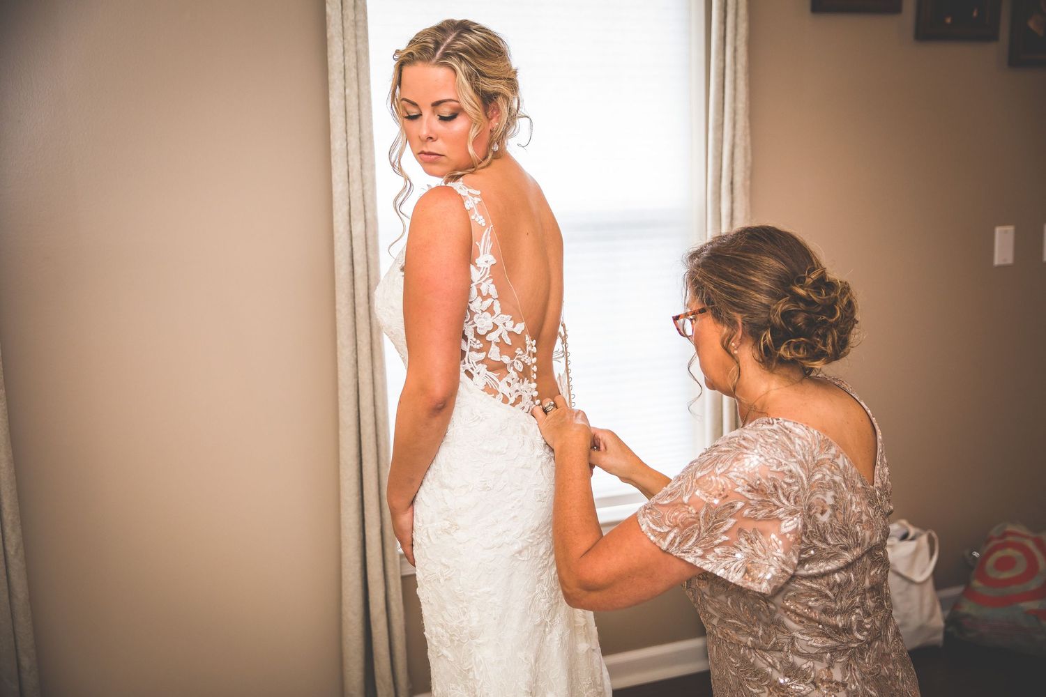 Wedding preparation moments captured in soft, natural window light.