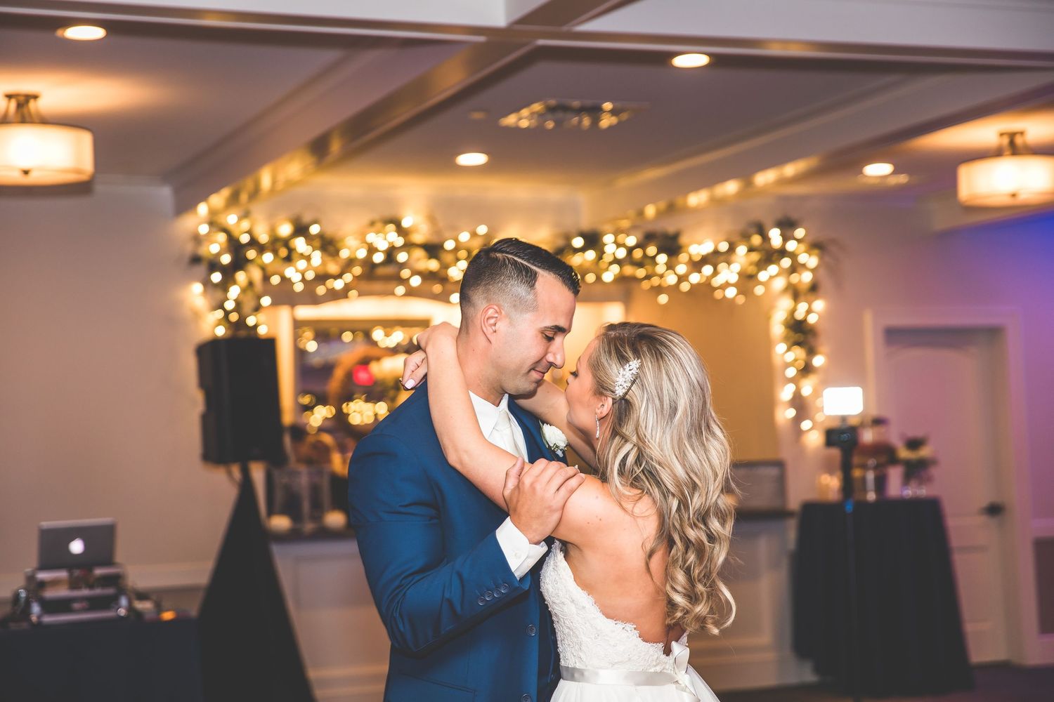 Wedding reception venue with elegant lighting and decorative elements.