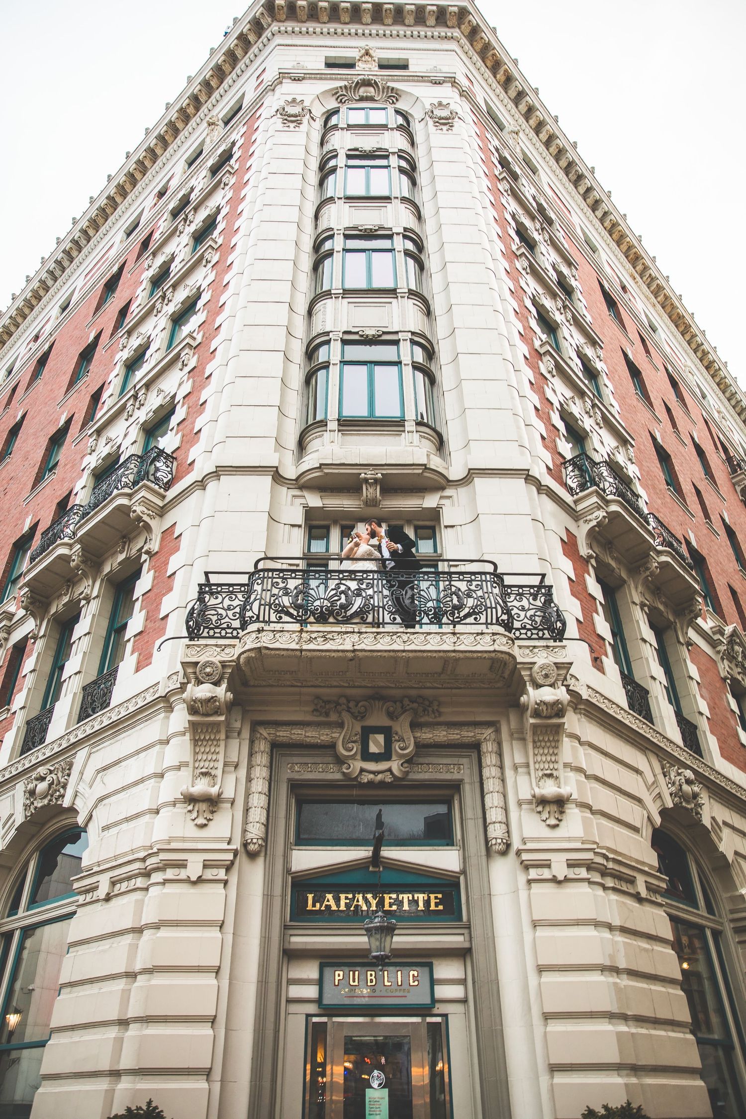 Elegant historic Lafayette Hotel building exterior featuring ornate architectural details and curved facade.