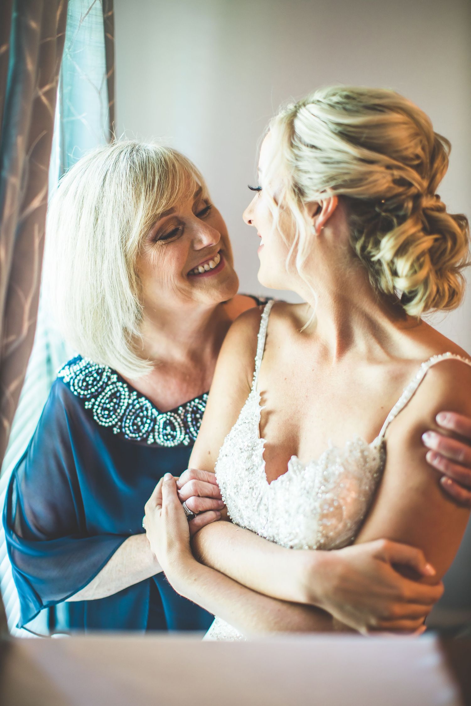 Intimate emotional moment captured during wedding preparations.