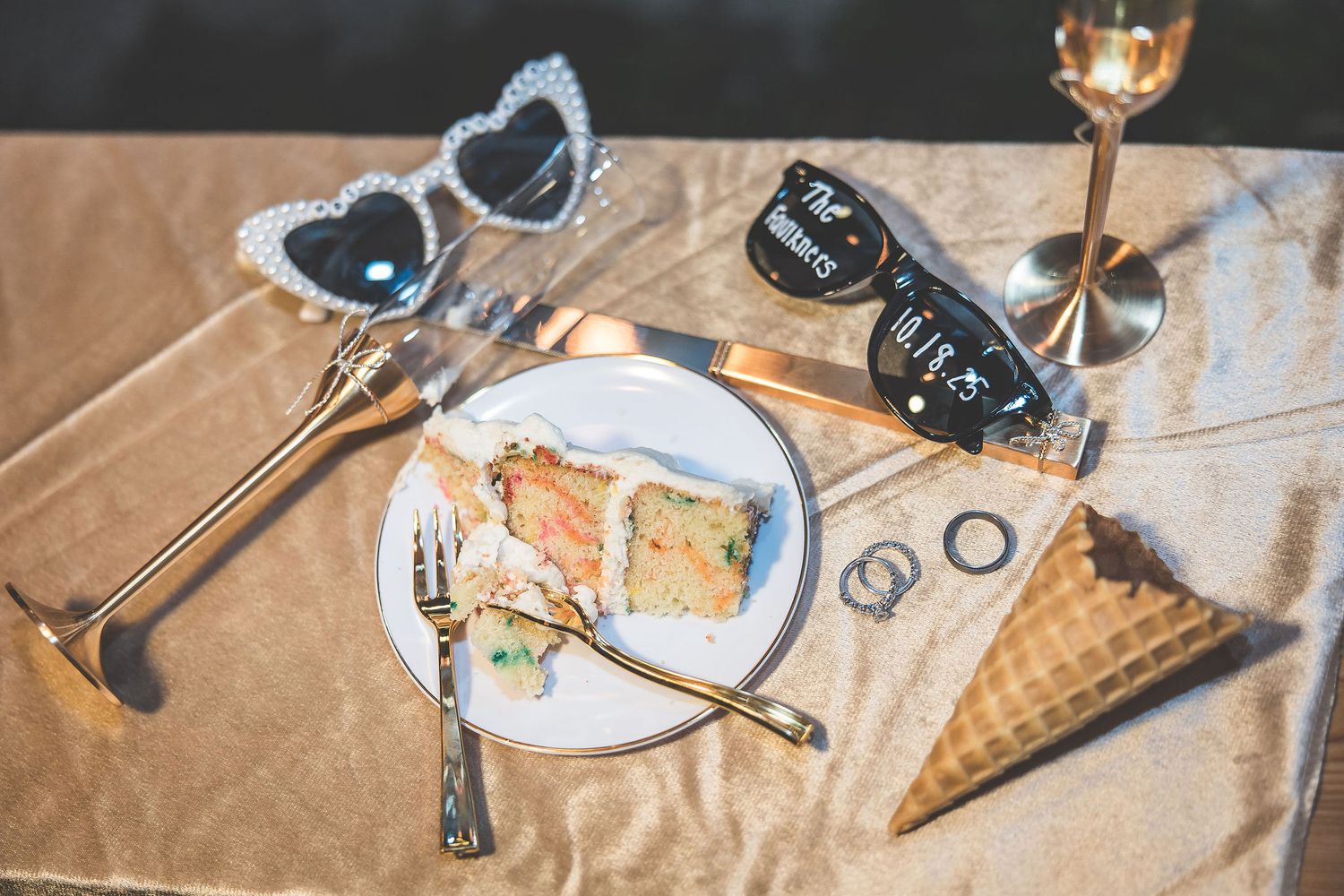 Artistic flatlay of ice cream cones and sunglasses on wooden surface.
