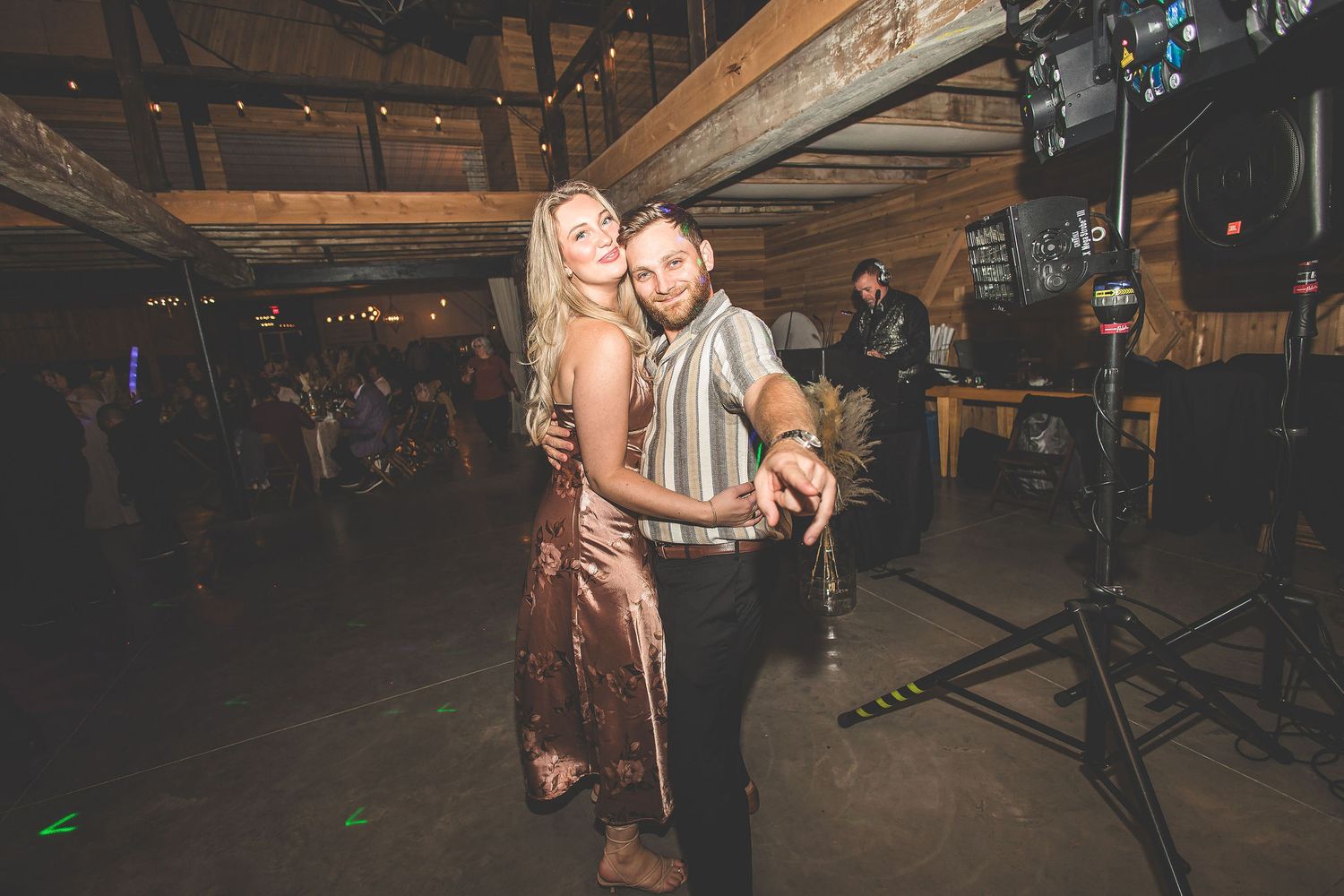 Guests enjoying themselves on the dance floor at a rustic barn wedding reception.