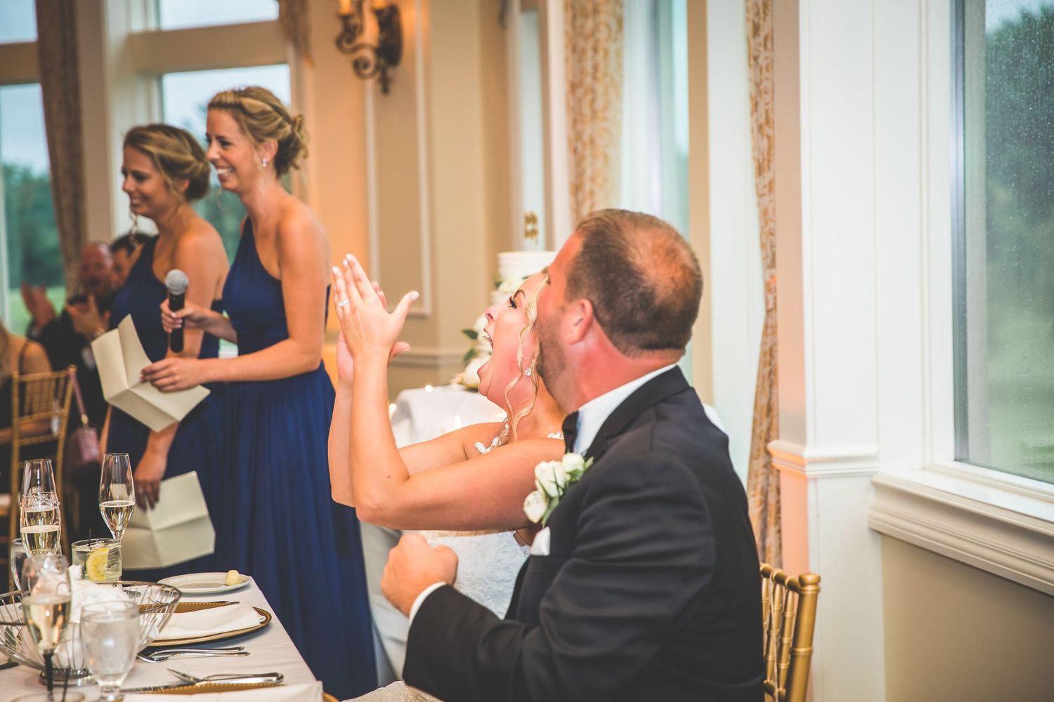 Wedding reception venue with white columns and elegant decor during a celebration.
