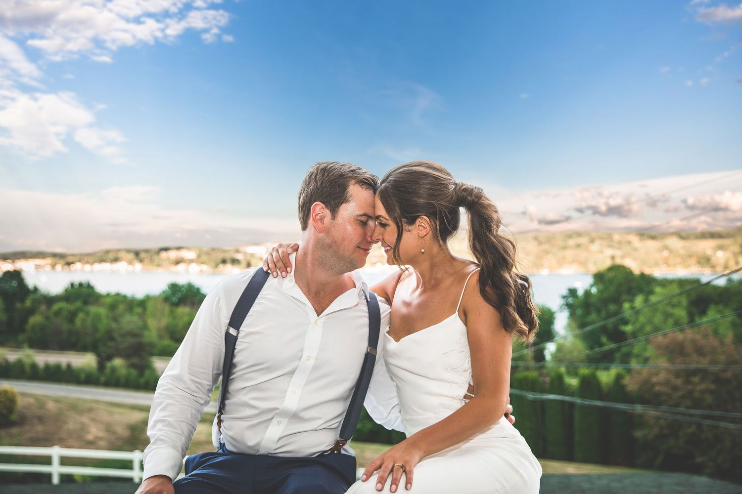 Couple shares romantic moment against scenic mountain backdrop during sunset.