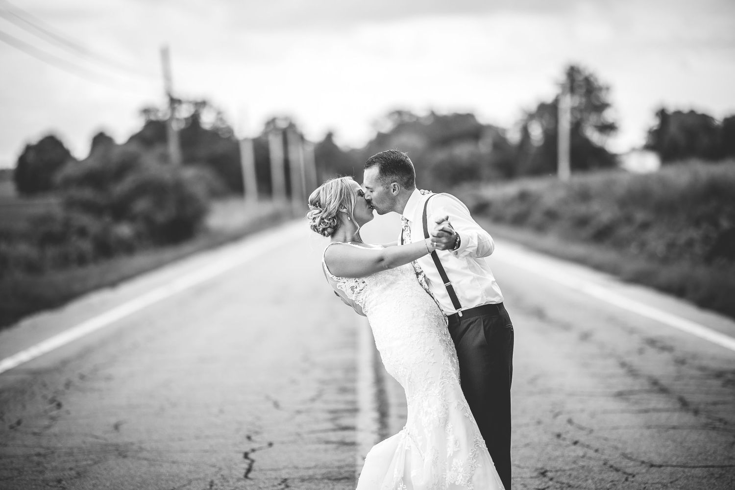 Artistic black and white wedding photography series on a country road.